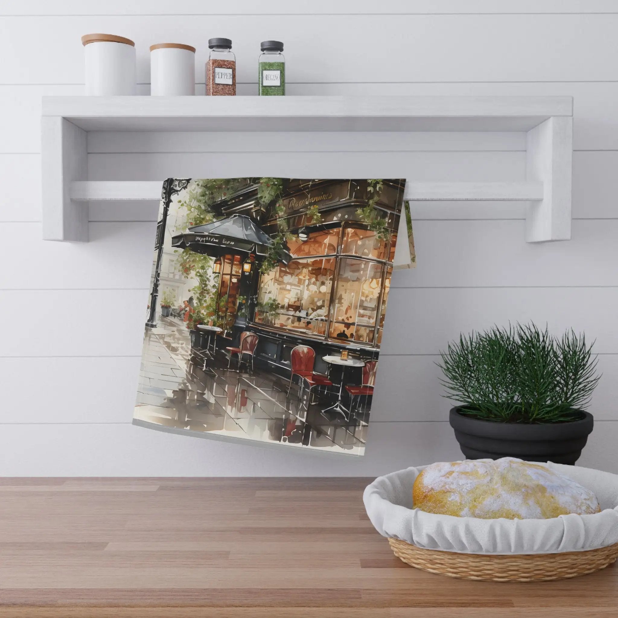 Kitchen Towel | a tea towel hanging on a wall next to a potted plant