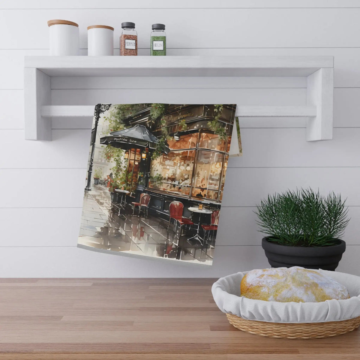 Kitchen Towel | a tea towel hanging on a wall next to a potted plant