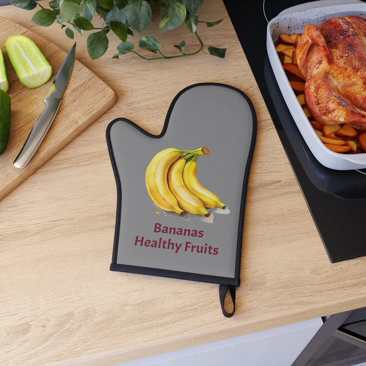 oven mitt | a cutting board topped with bananas next to a bowl of fruit