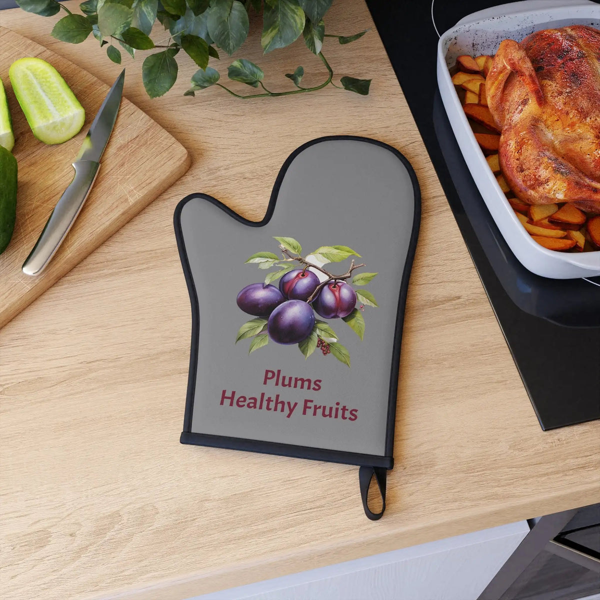 oven mitt | a wooden table topped with a cutting board and a tray of food