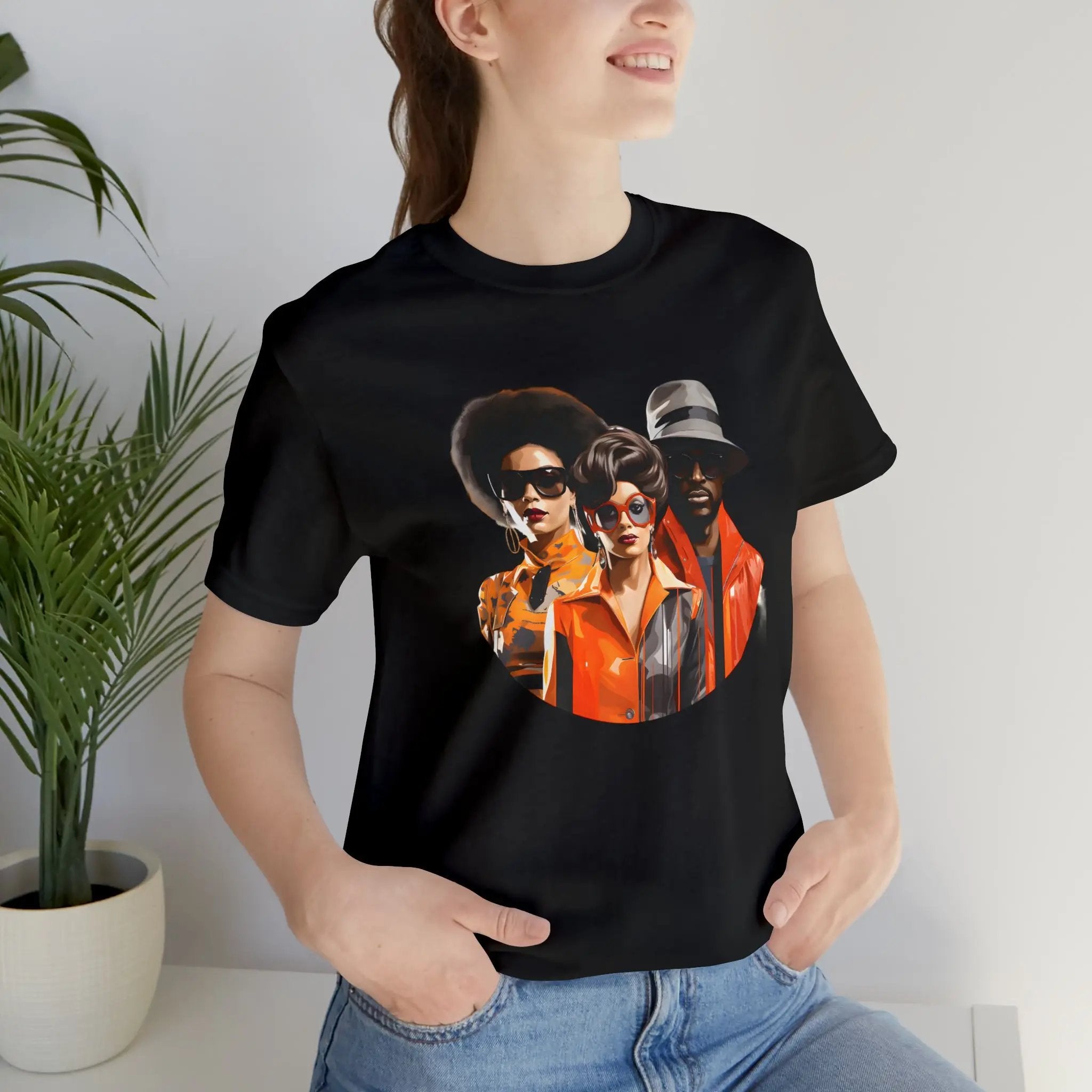 Couple t shirt | a woman wearing a black t - shirt with a picture of three men on it