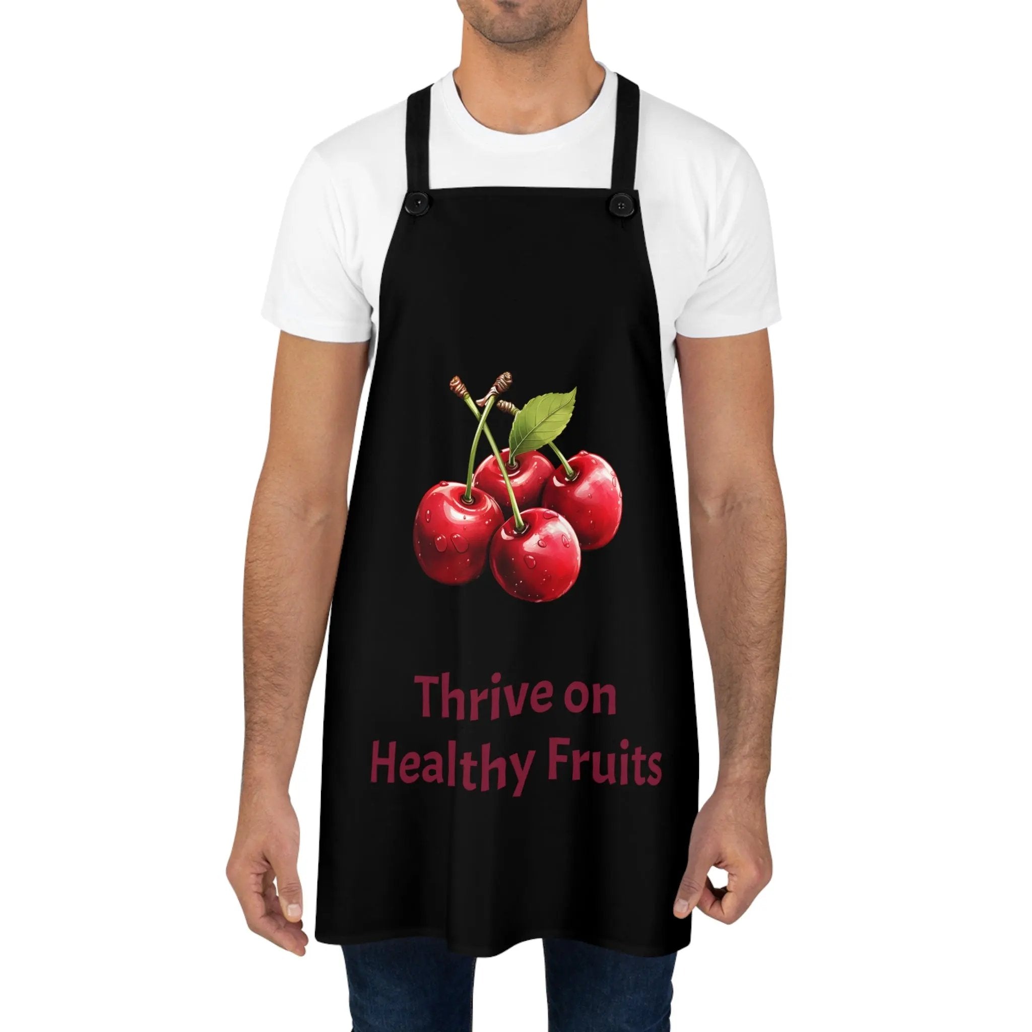 Chef Apron | a man wearing a black apron with cherries on it