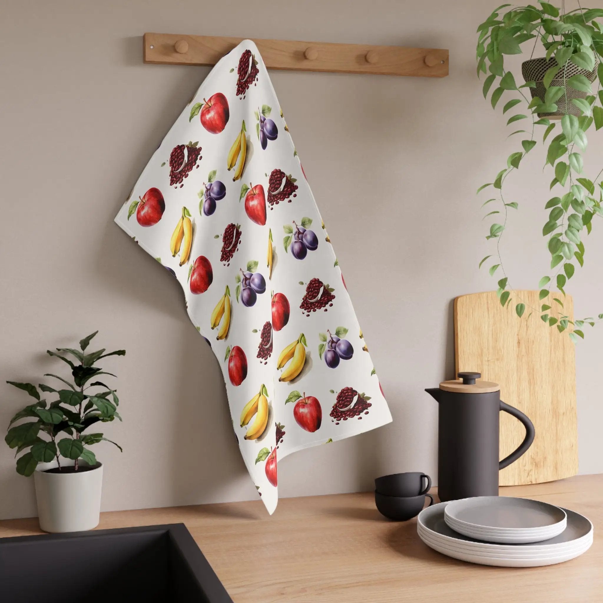 Kitchen Towel | a kitchen counter with a potted plant and a tea towel hanging on the wall