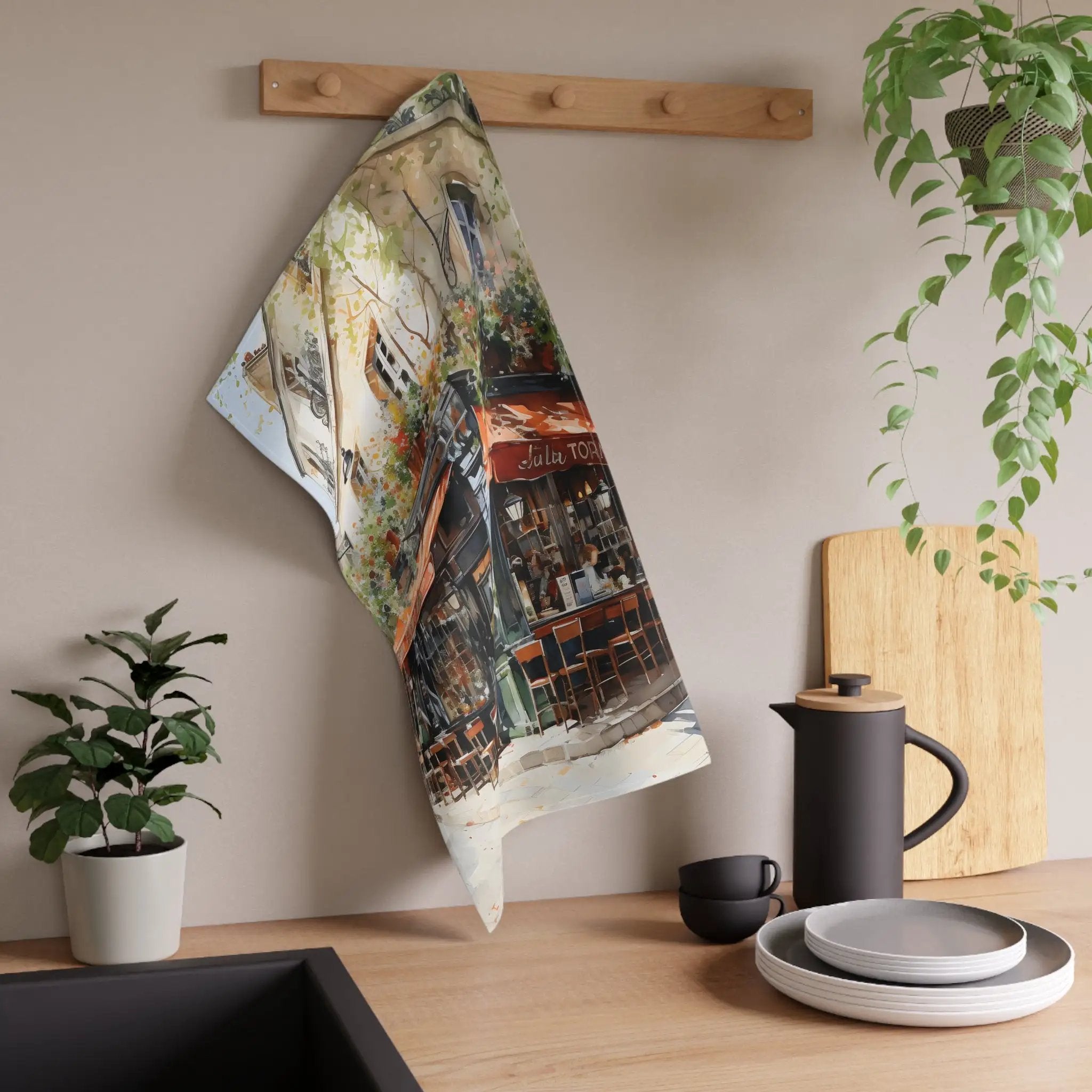 Kitchen Towel | a tea towel hanging on a wall next to a potted plant