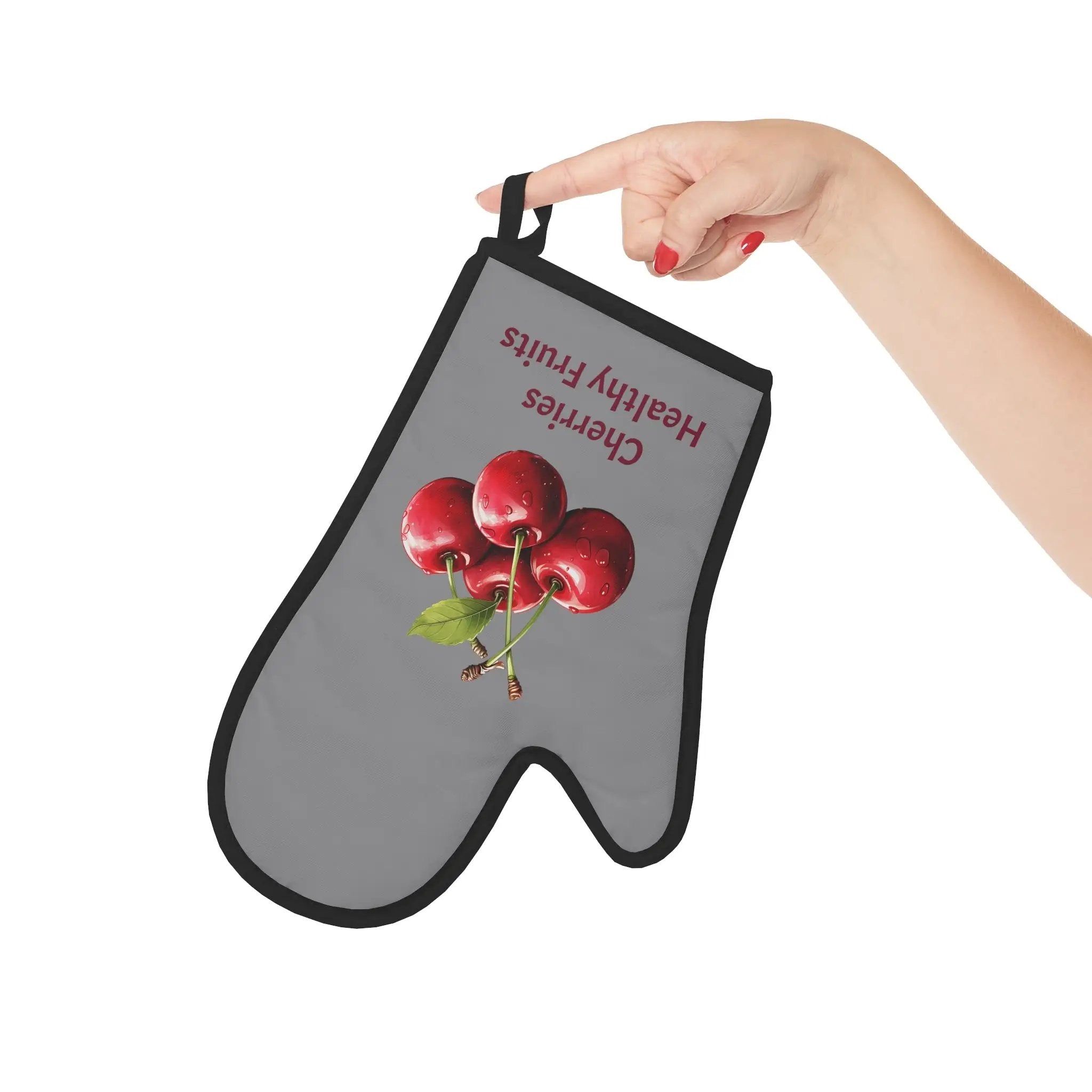 oven mitt | a person holding up an oven mitt with apples on it