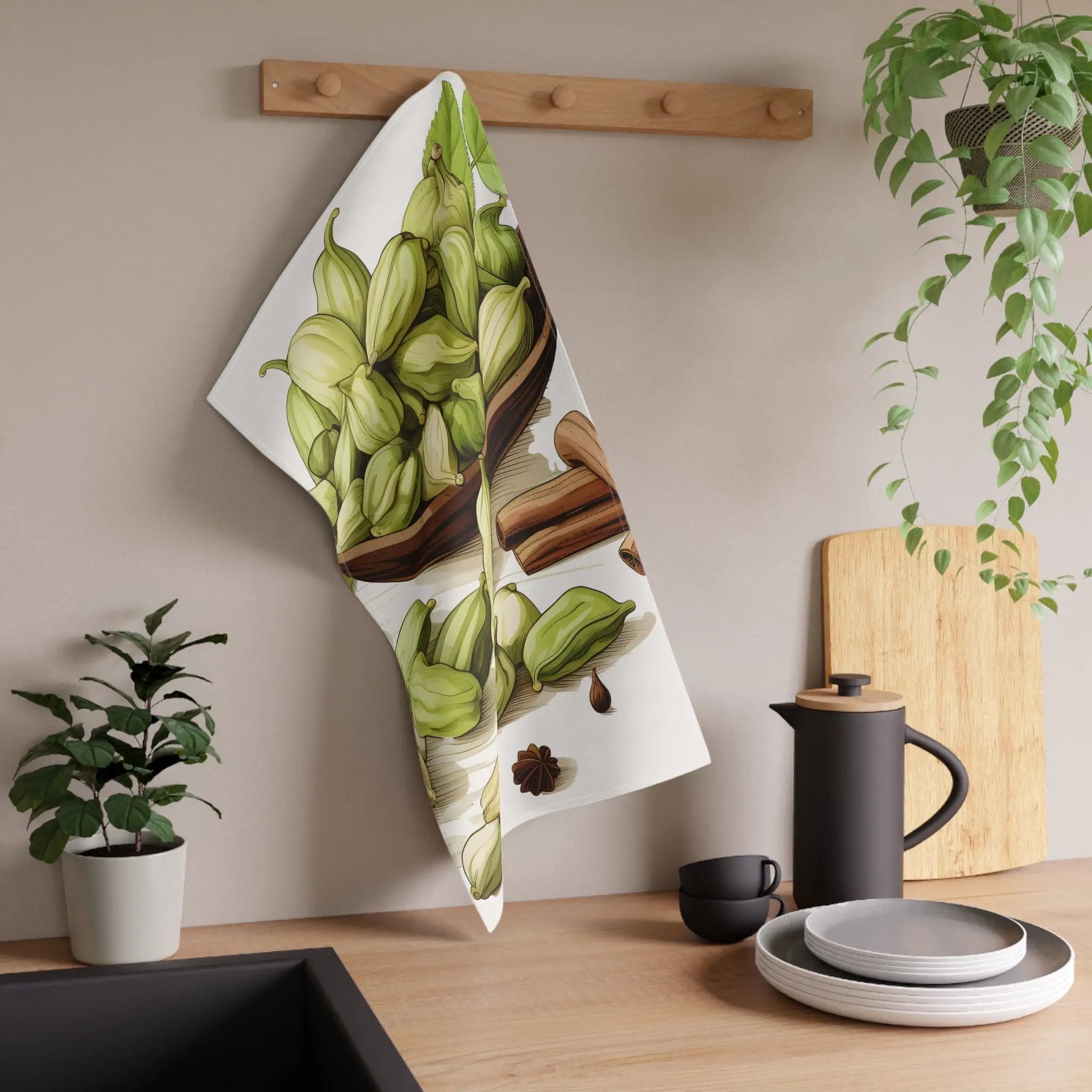 Kitchen Towel | a tea towel hanging on a wall next to a potted plant