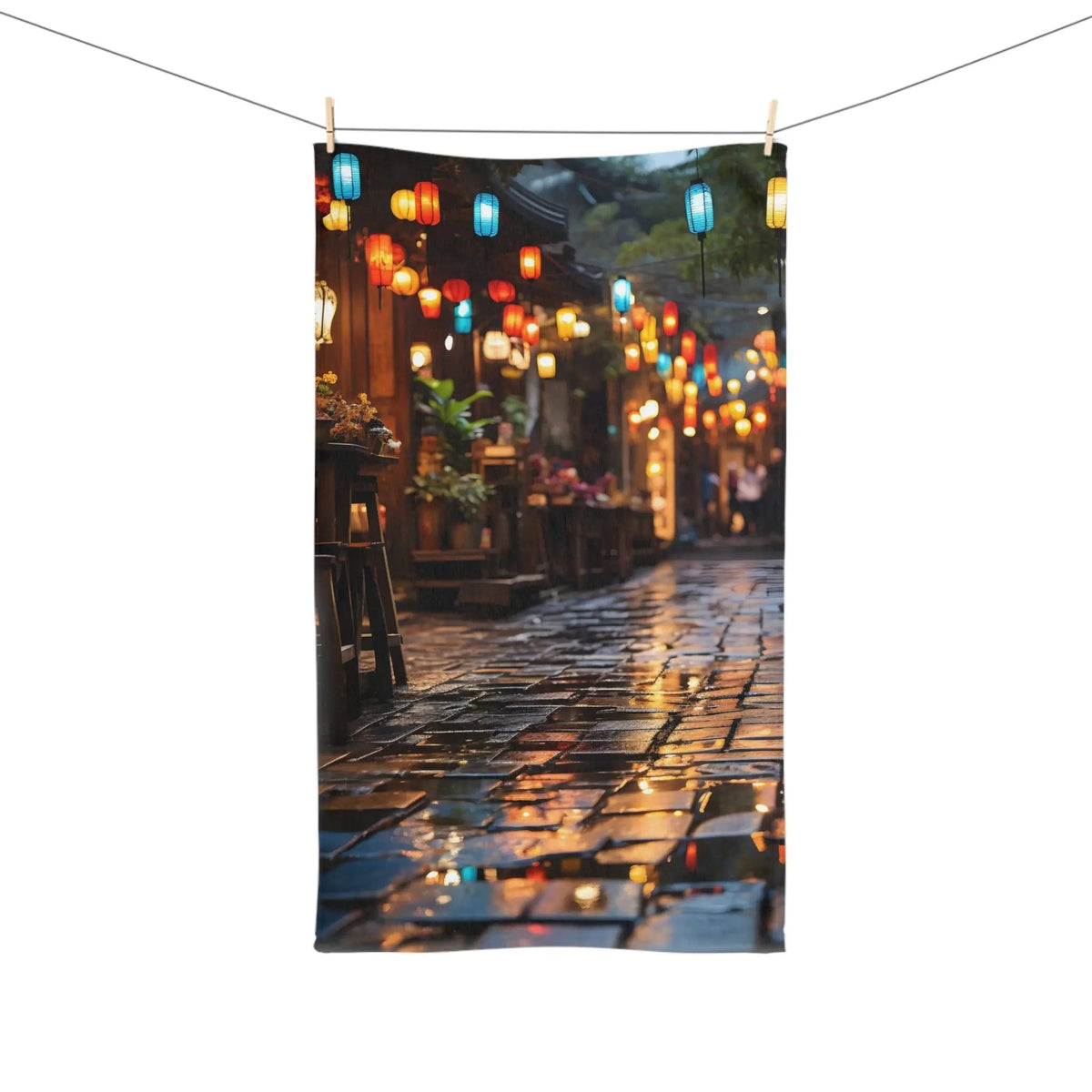 Hand Towel | a city street with lanterns hanging from a line