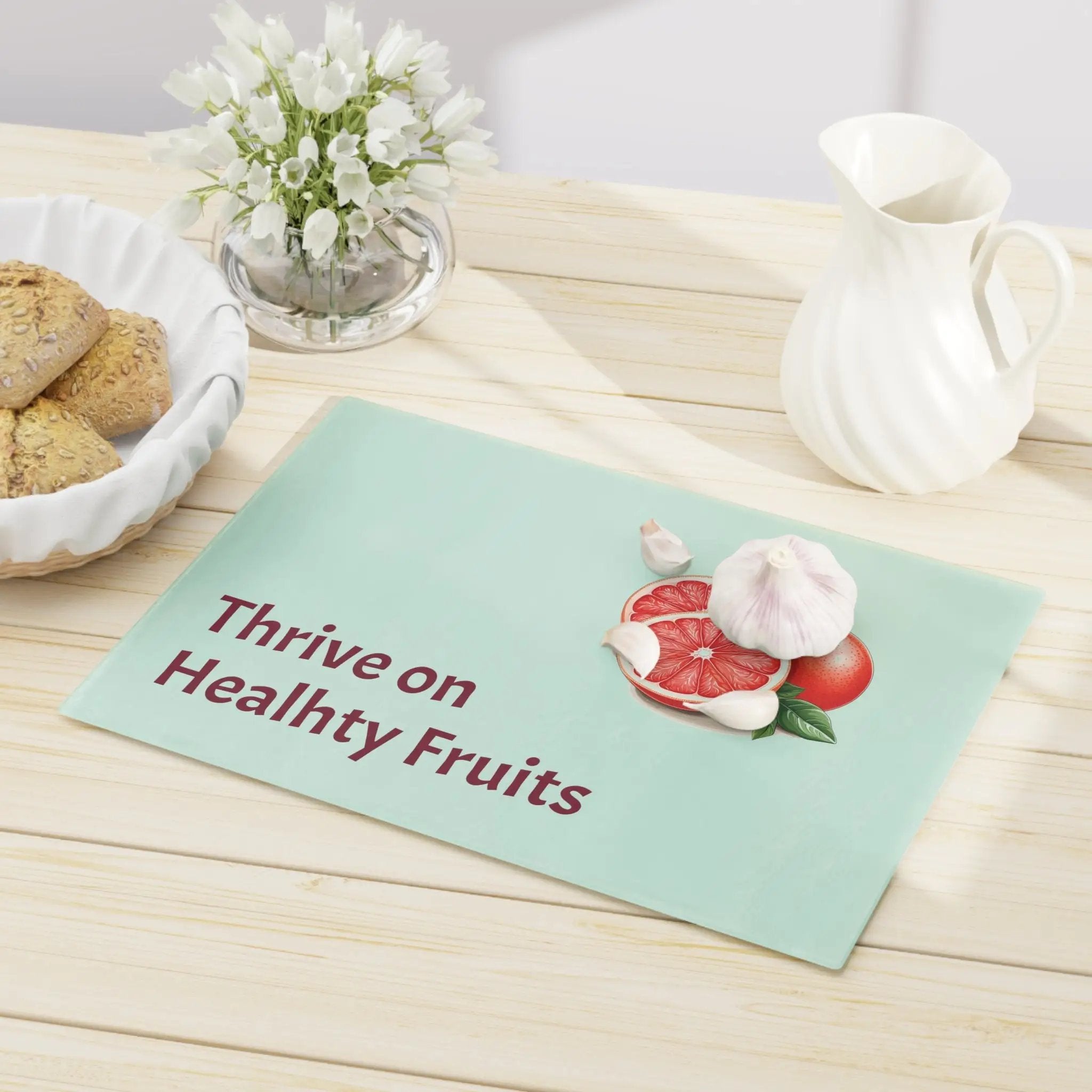 Cutting board | a table topped with a plate of cookies and a bowl of fruit