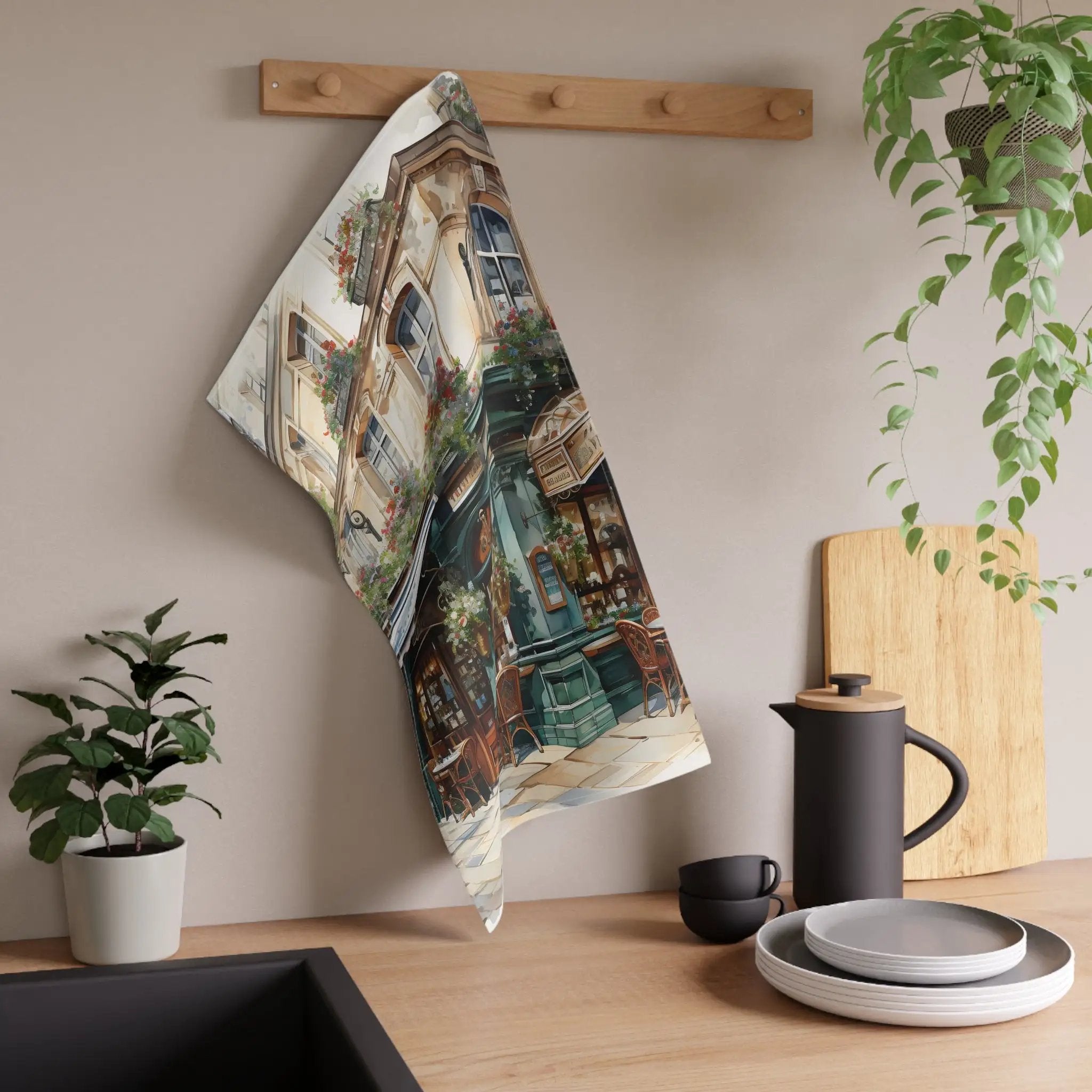 Kitchen Towel | a tea towel hanging on a wall next to a potted plant