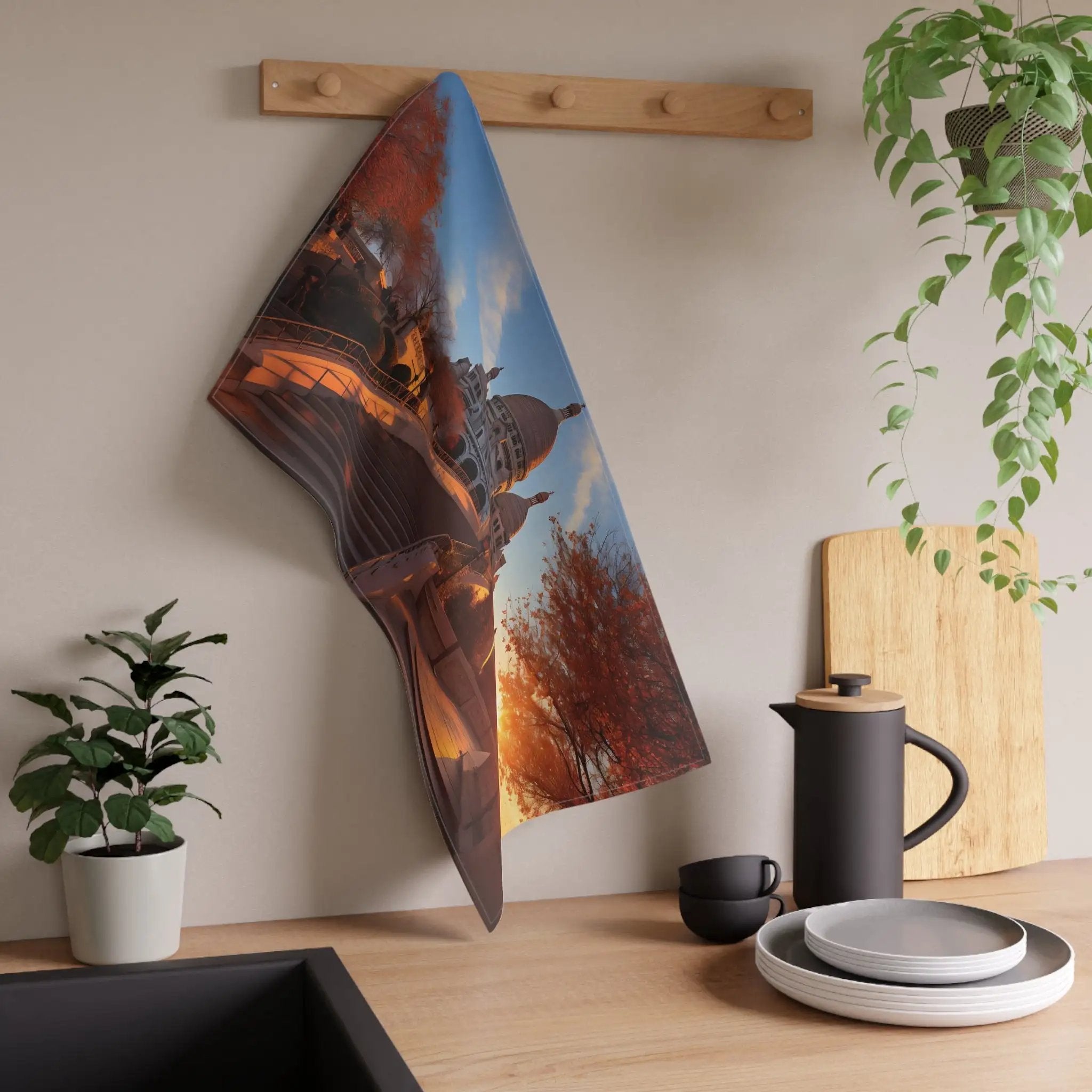 Kitchen Towel | a kitchen counter with a potted plant and a picture hanging on the wall