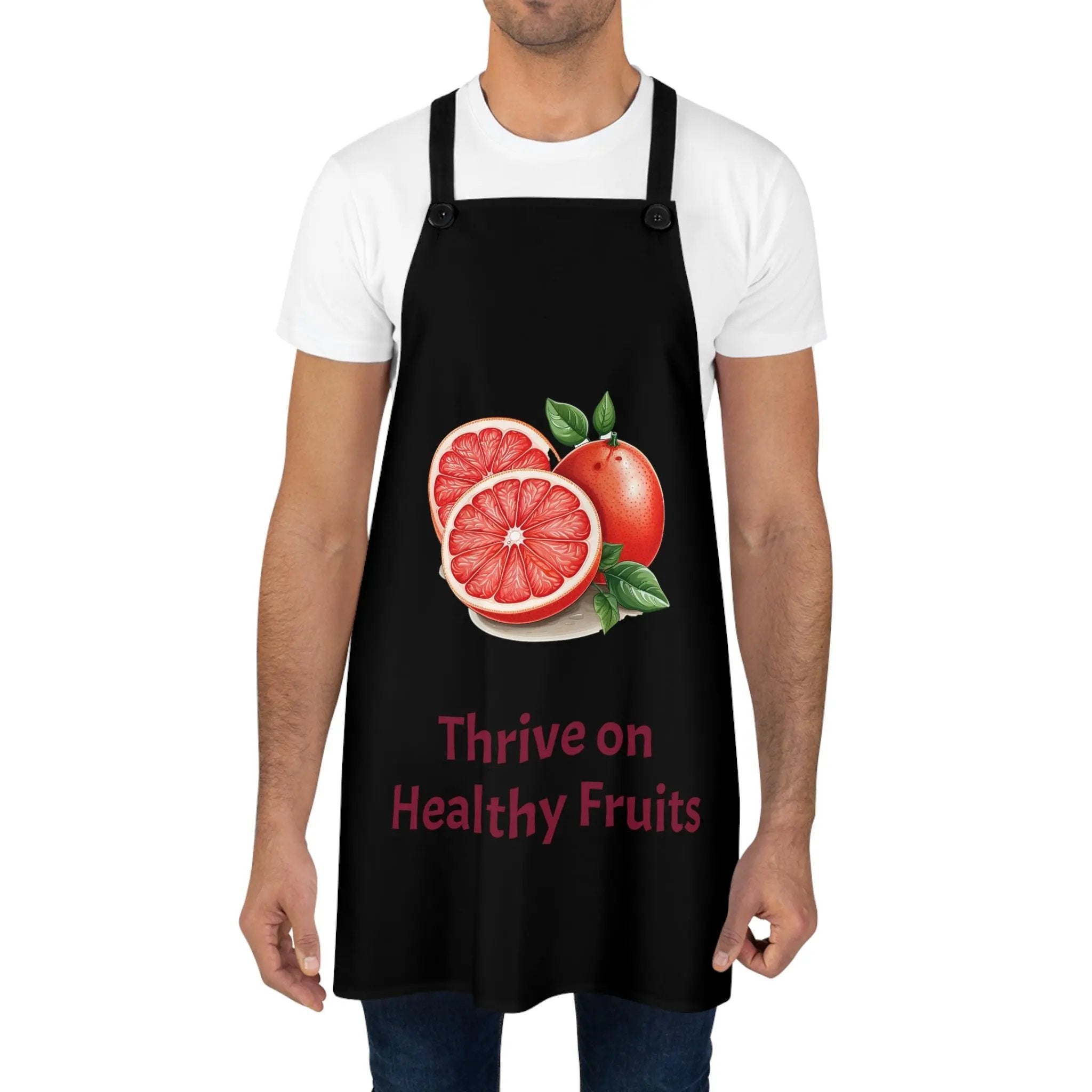 Chef Apron | a man wearing a black apron with a grapefruit on it