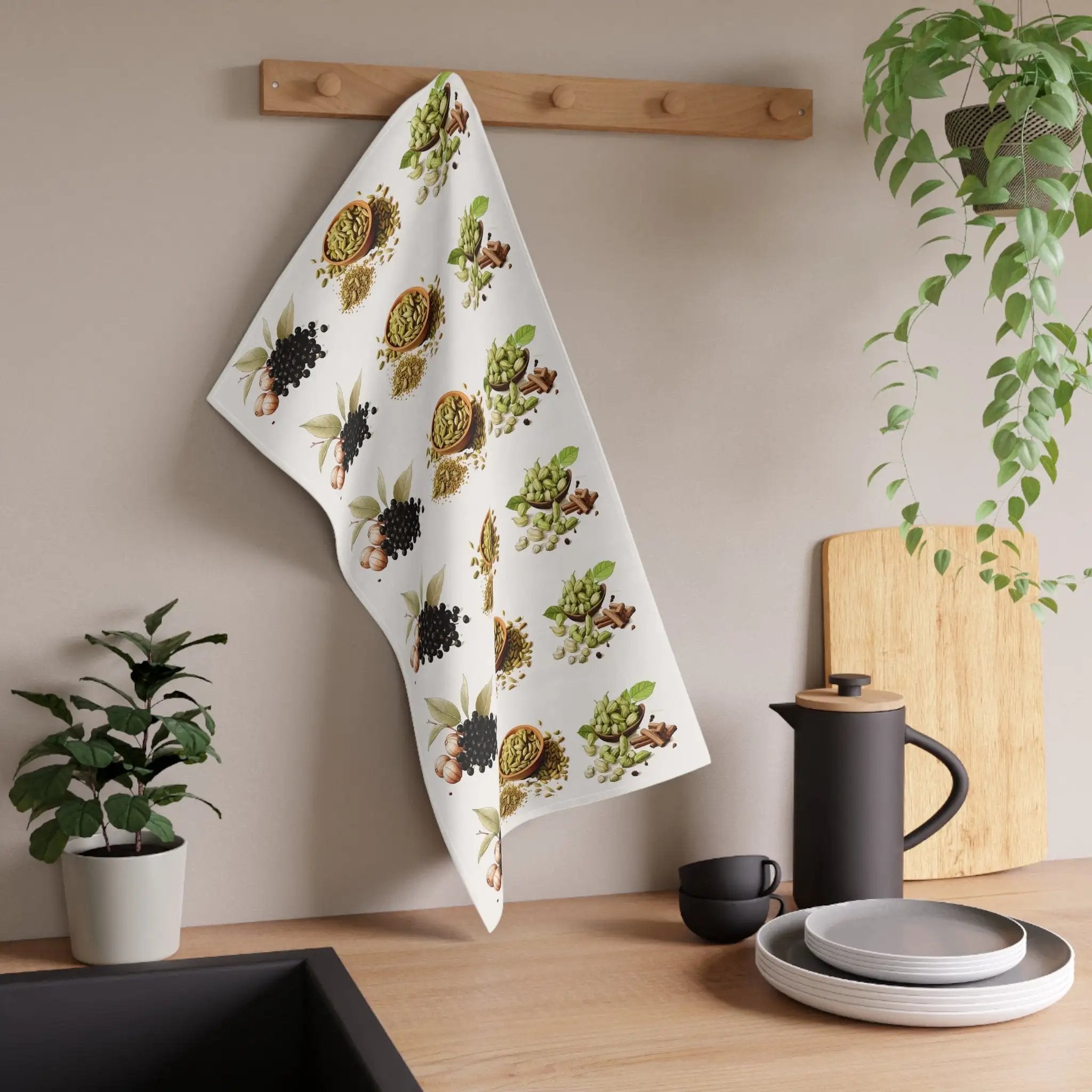 Kitchen Towel | a tea towel hanging on a wall next to a potted plant