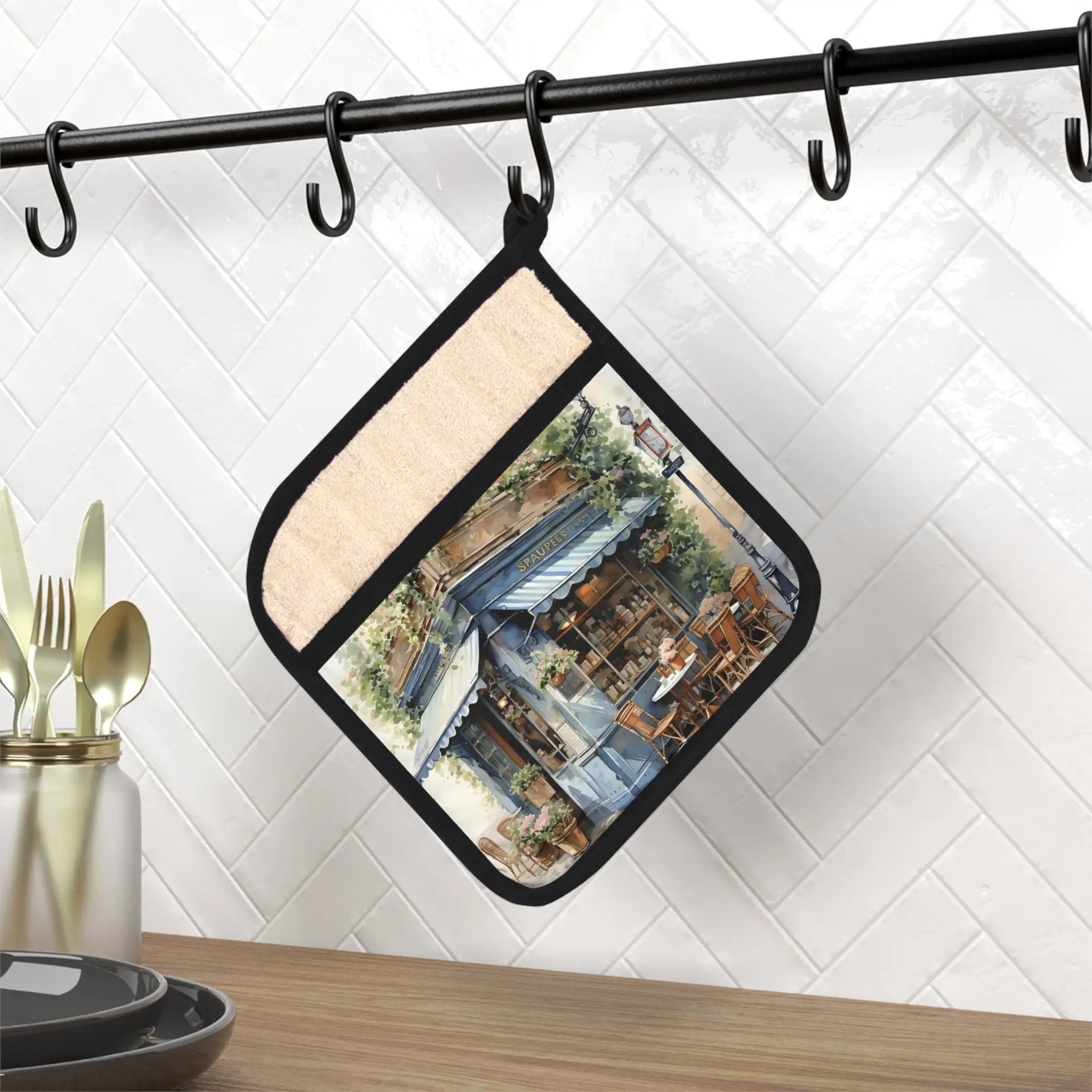 Pot Holder | a pot holder with a picture of a house hanging from it