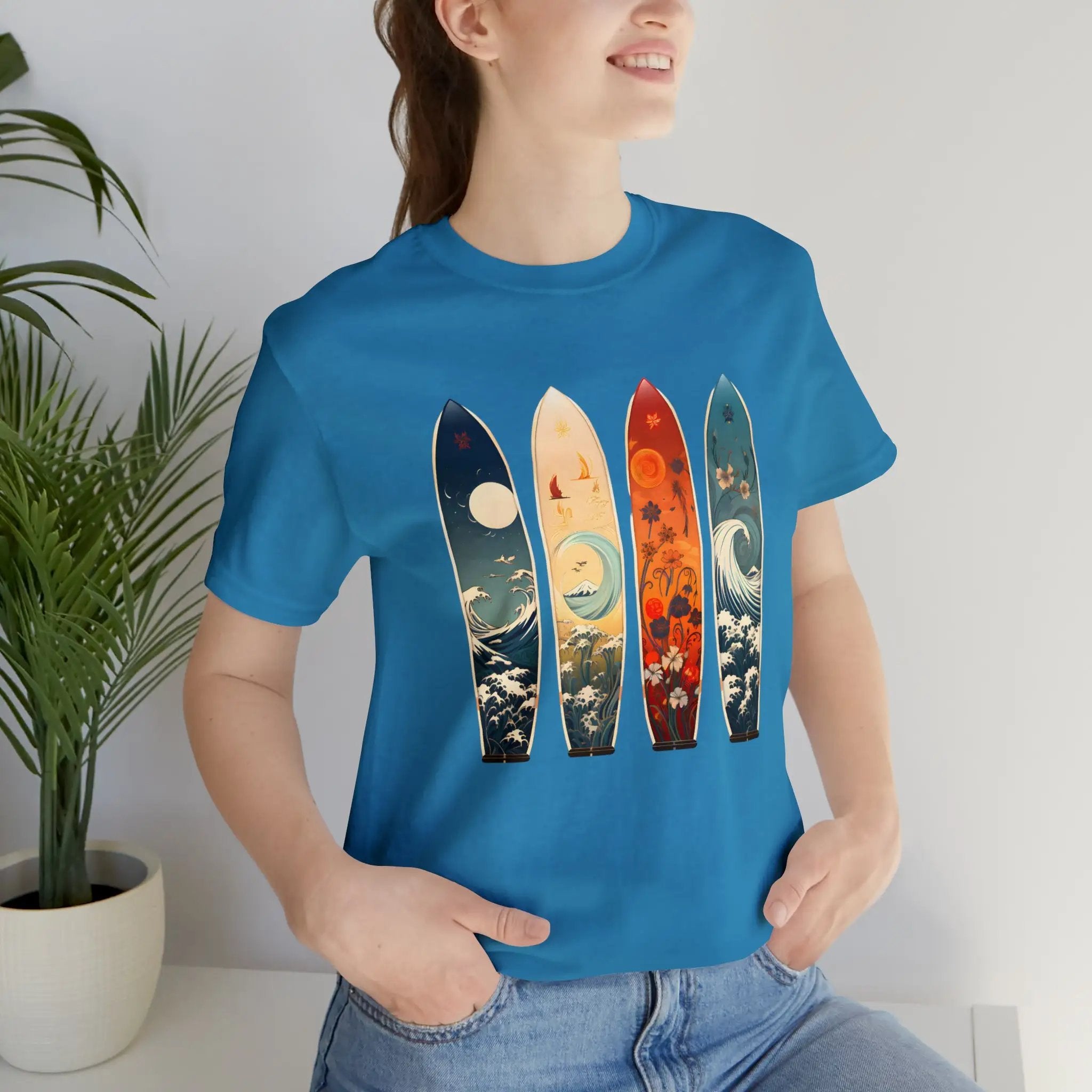 Couple t shirt | a woman wearing a blue shirt with three surfboards on it