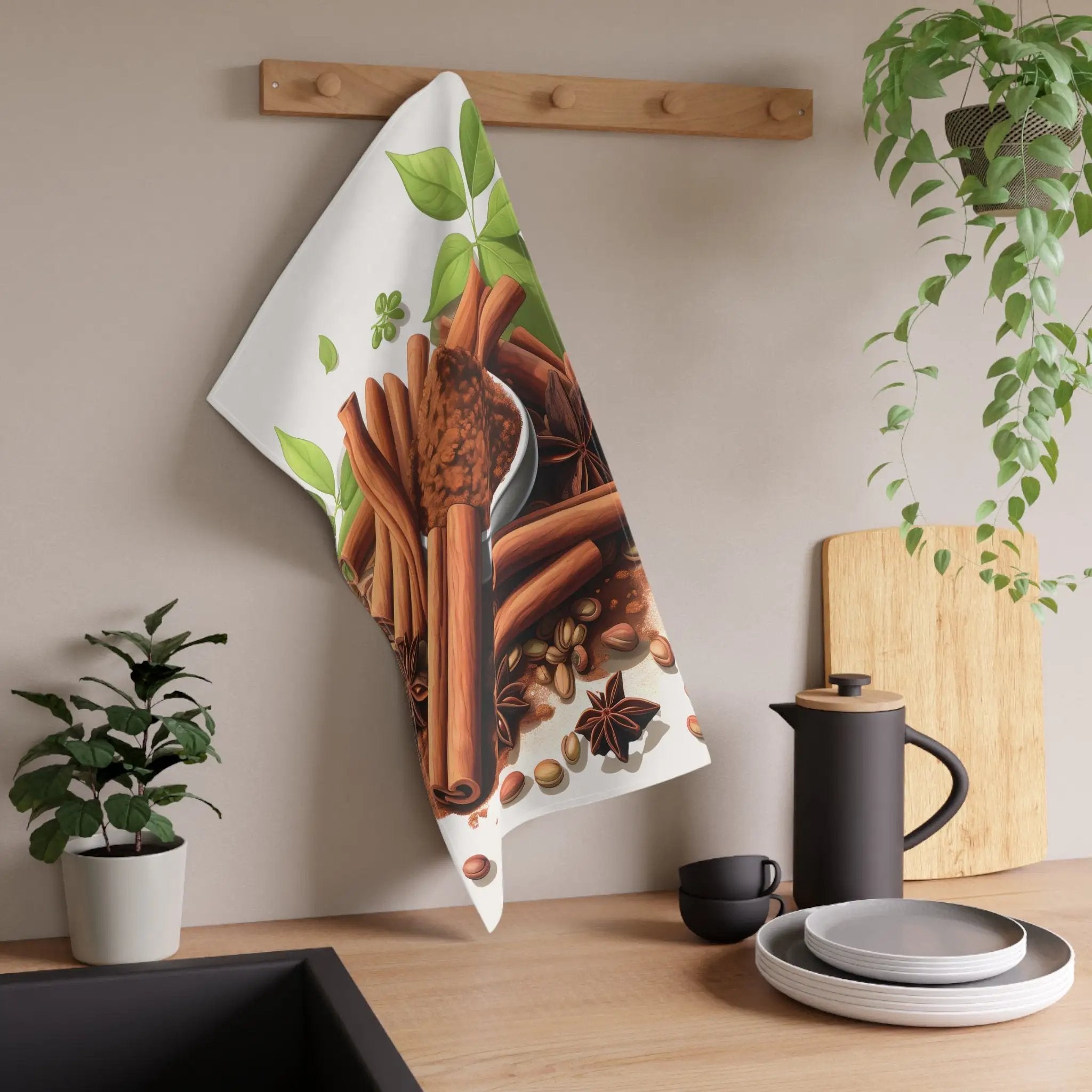 Kitchen Towel | a tea towel hanging on a wall next to a potted plant