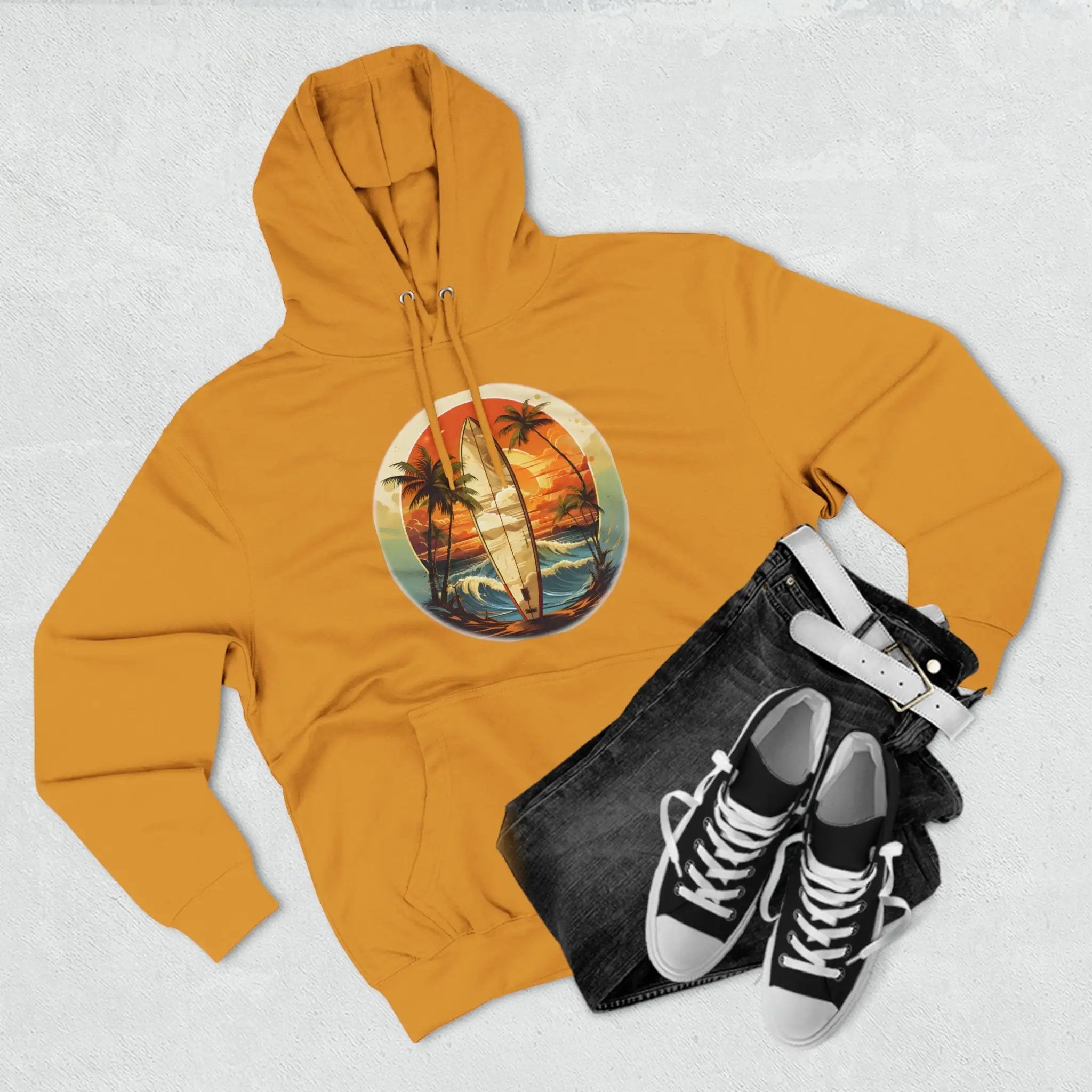 a yellow hoodie with a picture of a surfboard and palm trees on it