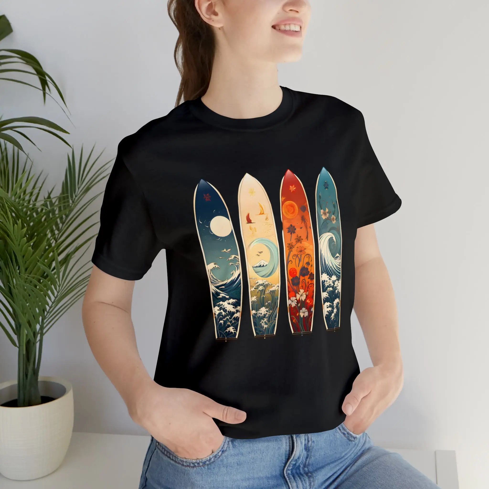 Couple t shirt | a woman wearing a black shirt with four surfboards on it