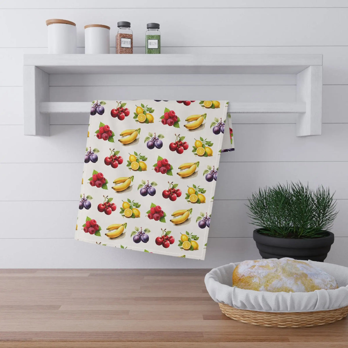 Kitchen Towel | a kitchen towel hanging on a wall next to a bowl of fruit