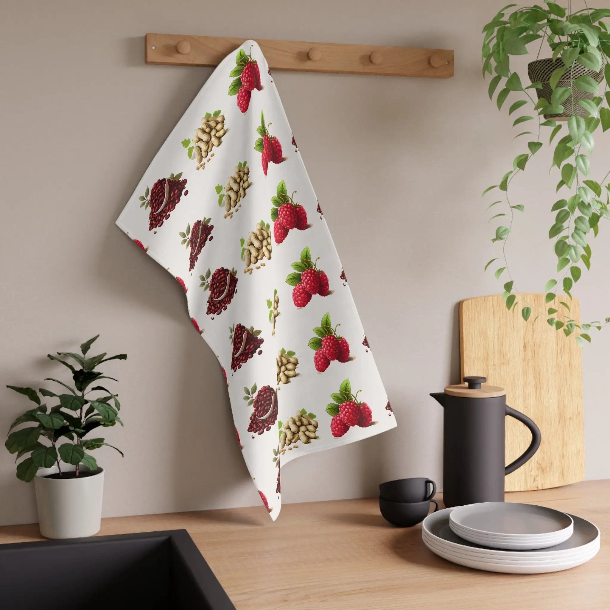 Kitchen Towel | a tea towel hanging on a wall next to a potted plant