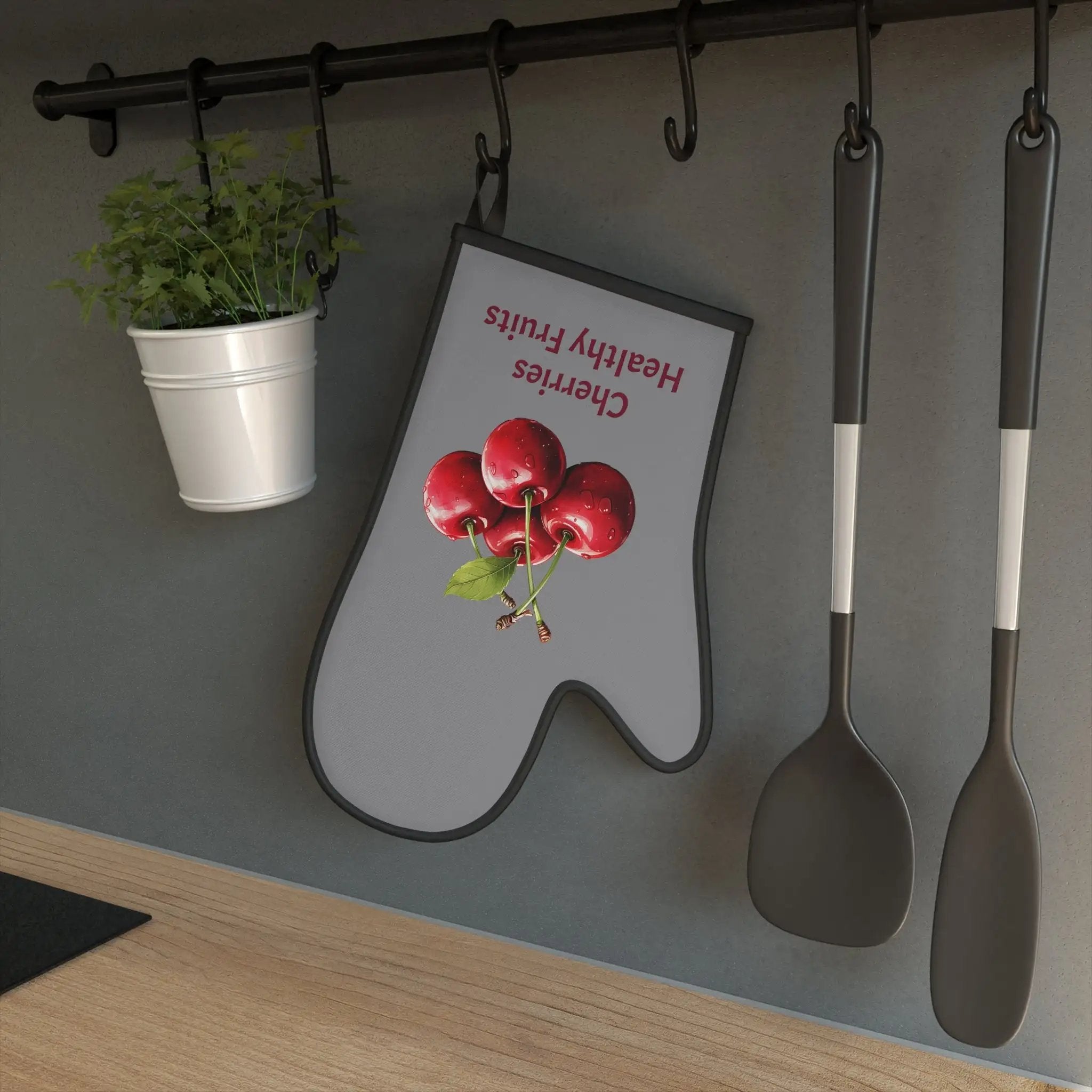 oven mitt | spoons and spoons hanging on a wall next to a potted plant