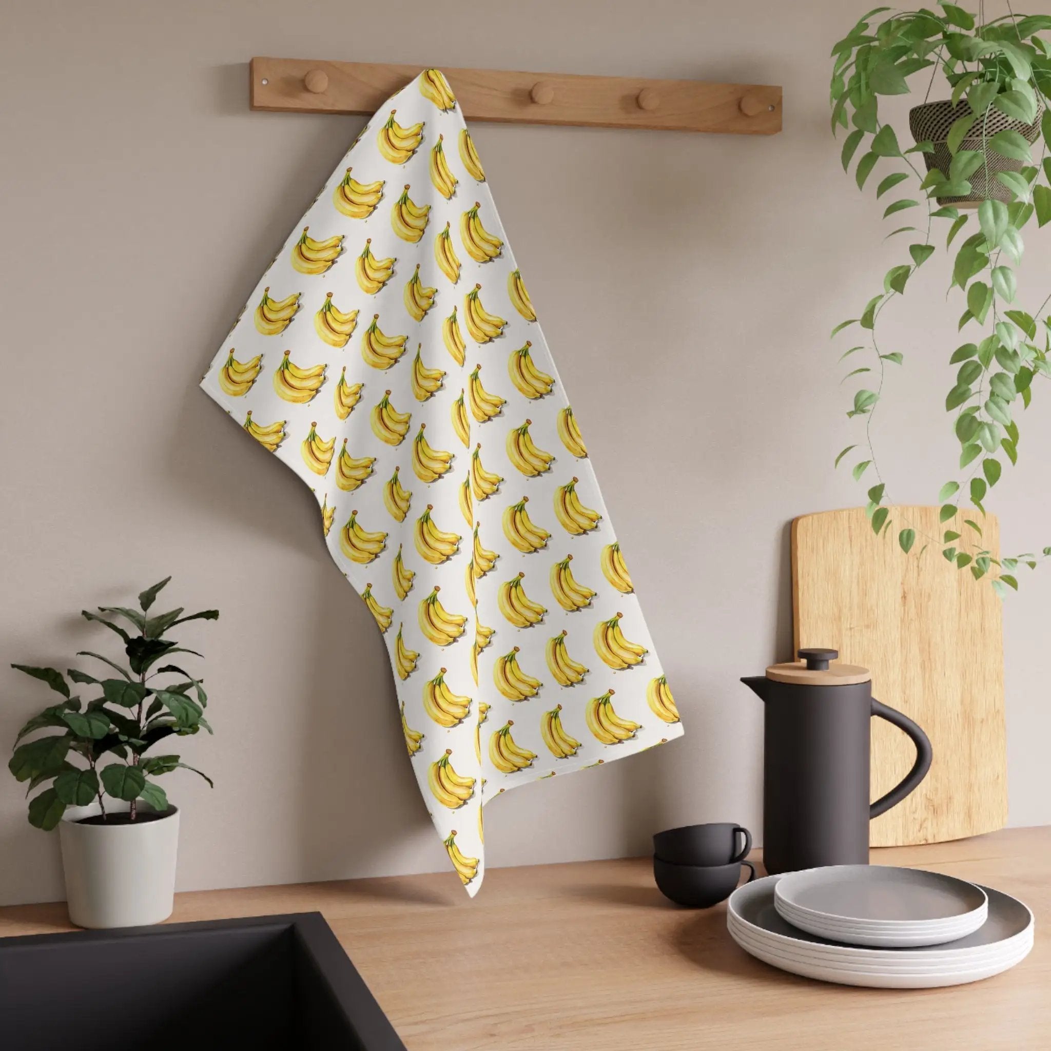 Kitchen Towel | a kitchen counter with a banana towel hanging on the wall