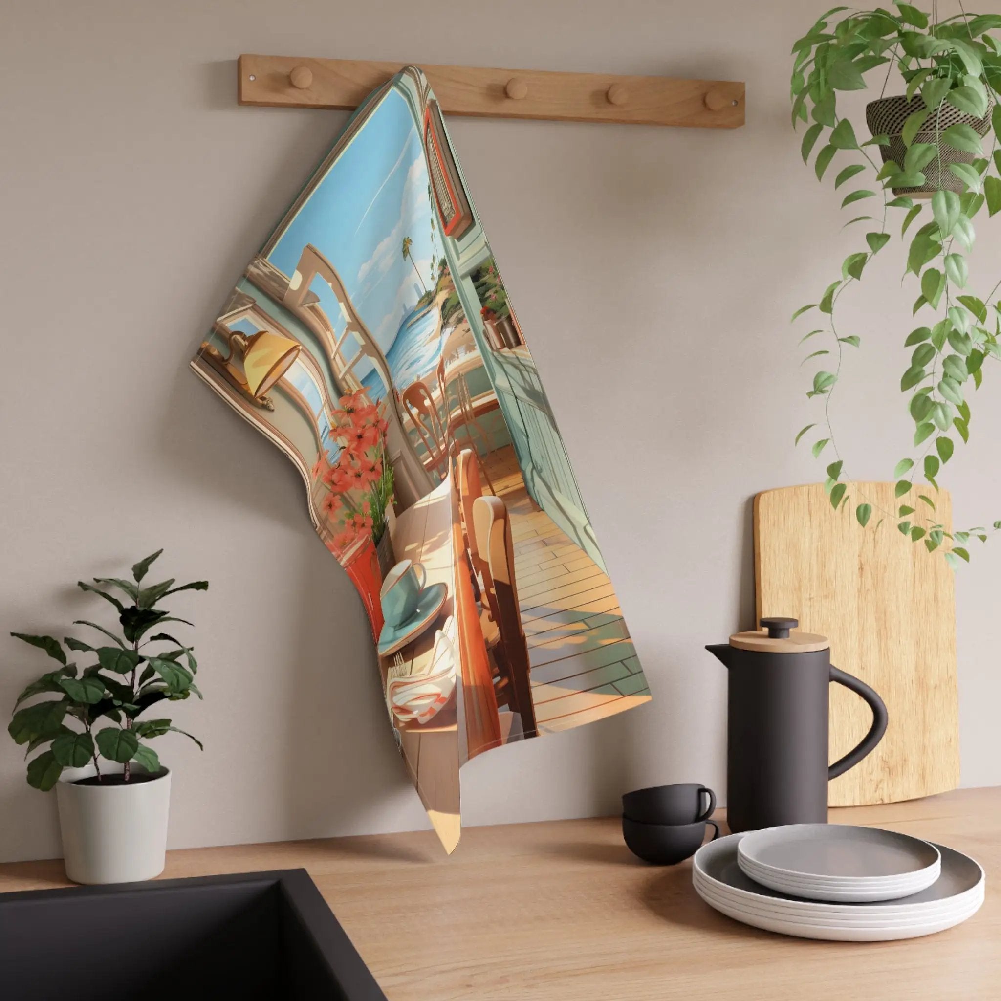 Kitchen Towel | a tea towel hanging on a wall next to a potted plant