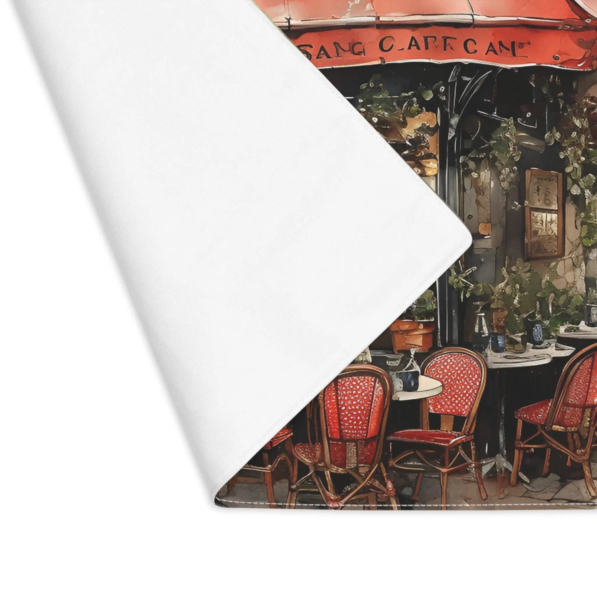 Placemat | a painting of a cafe with red chairs