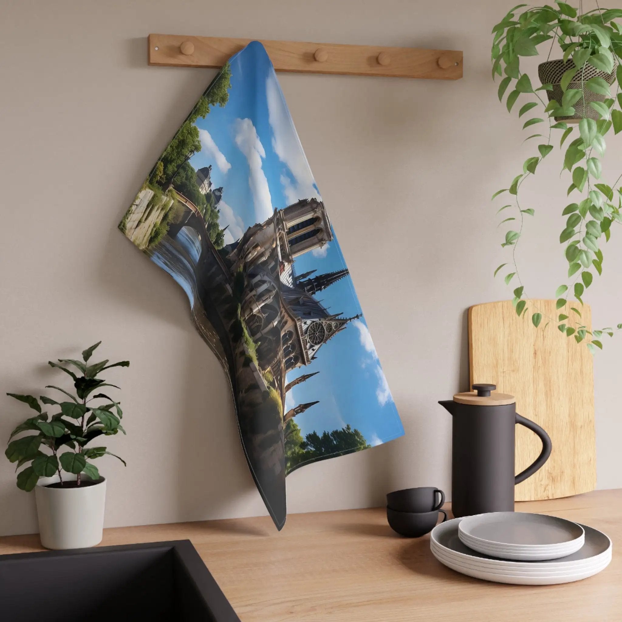 Kitchen Towel | a tea towel hanging on a wall next to a potted plant