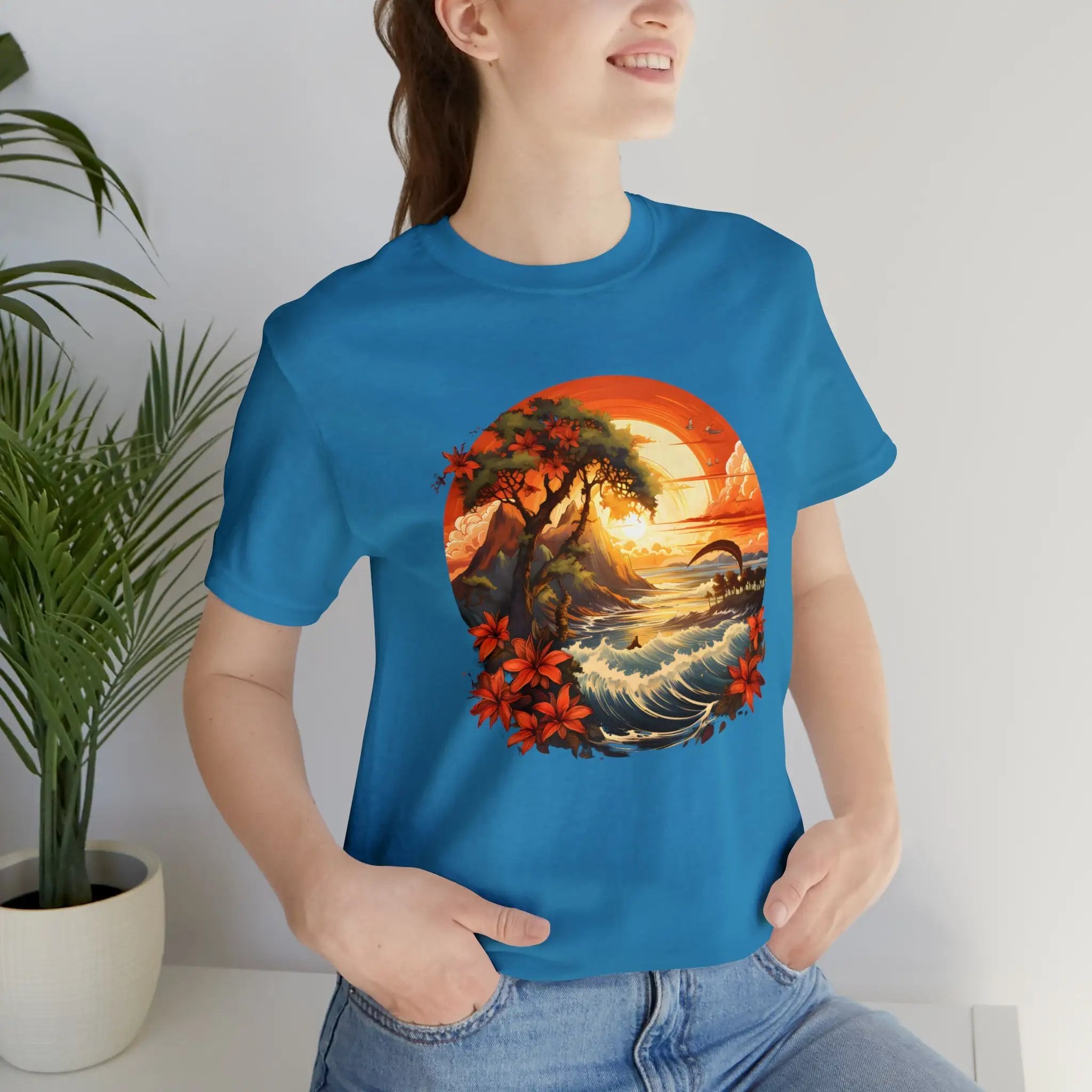 Couple t shirt | a woman wearing a blue t - shirt with a painting of a sunset