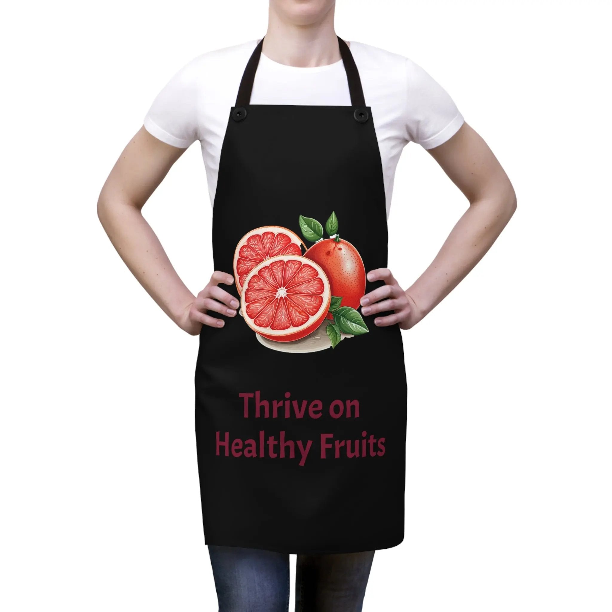 Chef Apron | a woman wearing a black apron with a grapefruit on it