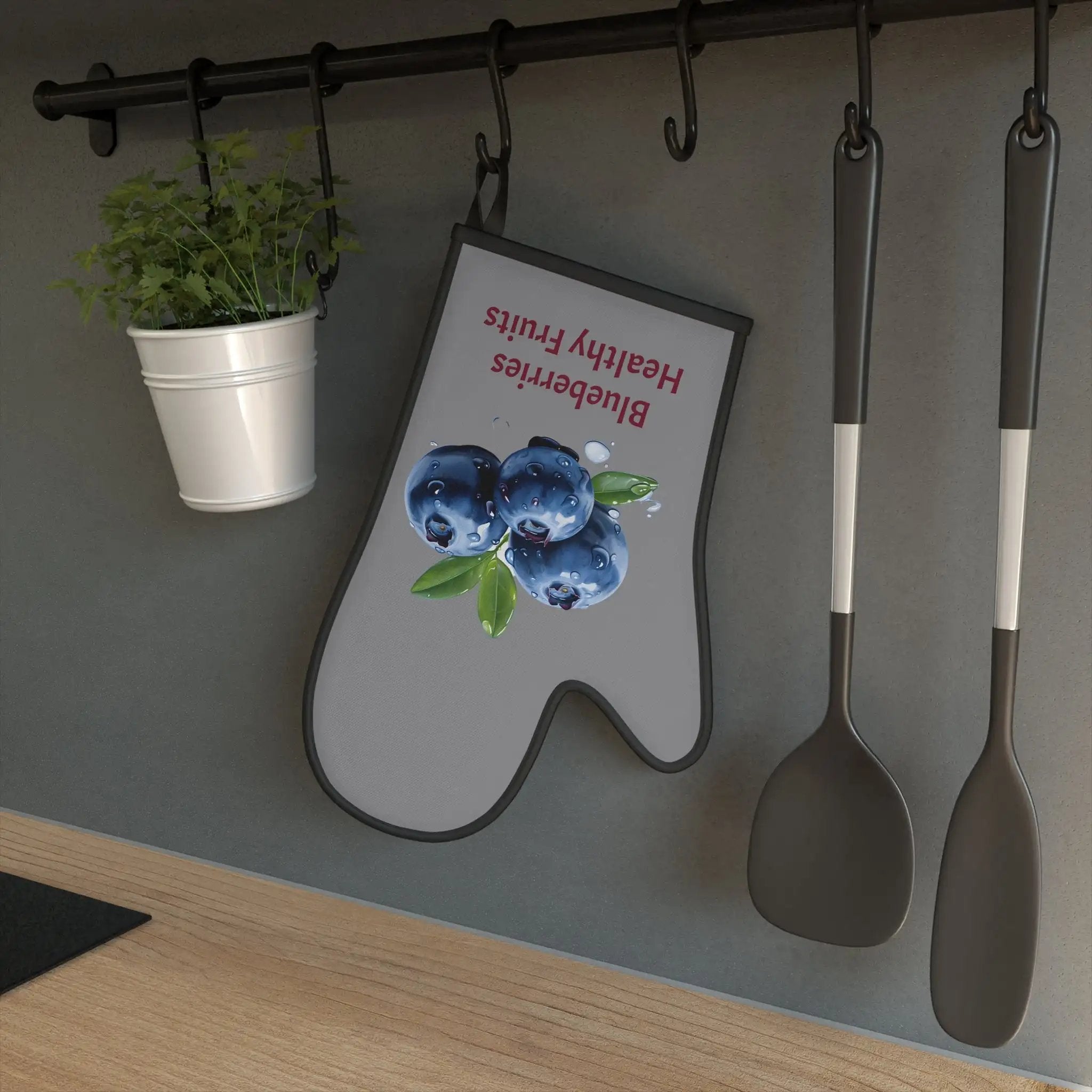 oven mitt | spoons and spoons hanging on a wall next to a potted plant