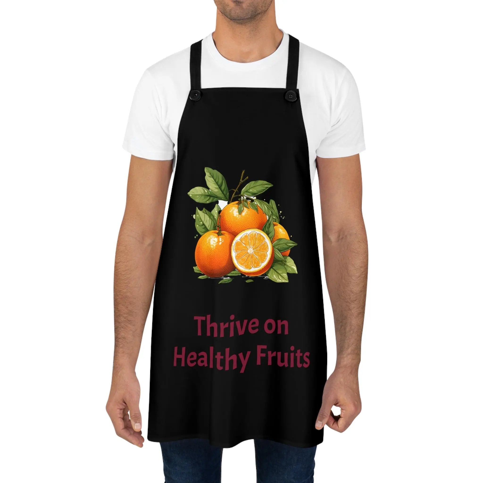 Chef Apron | a man wearing a black apron with oranges on it