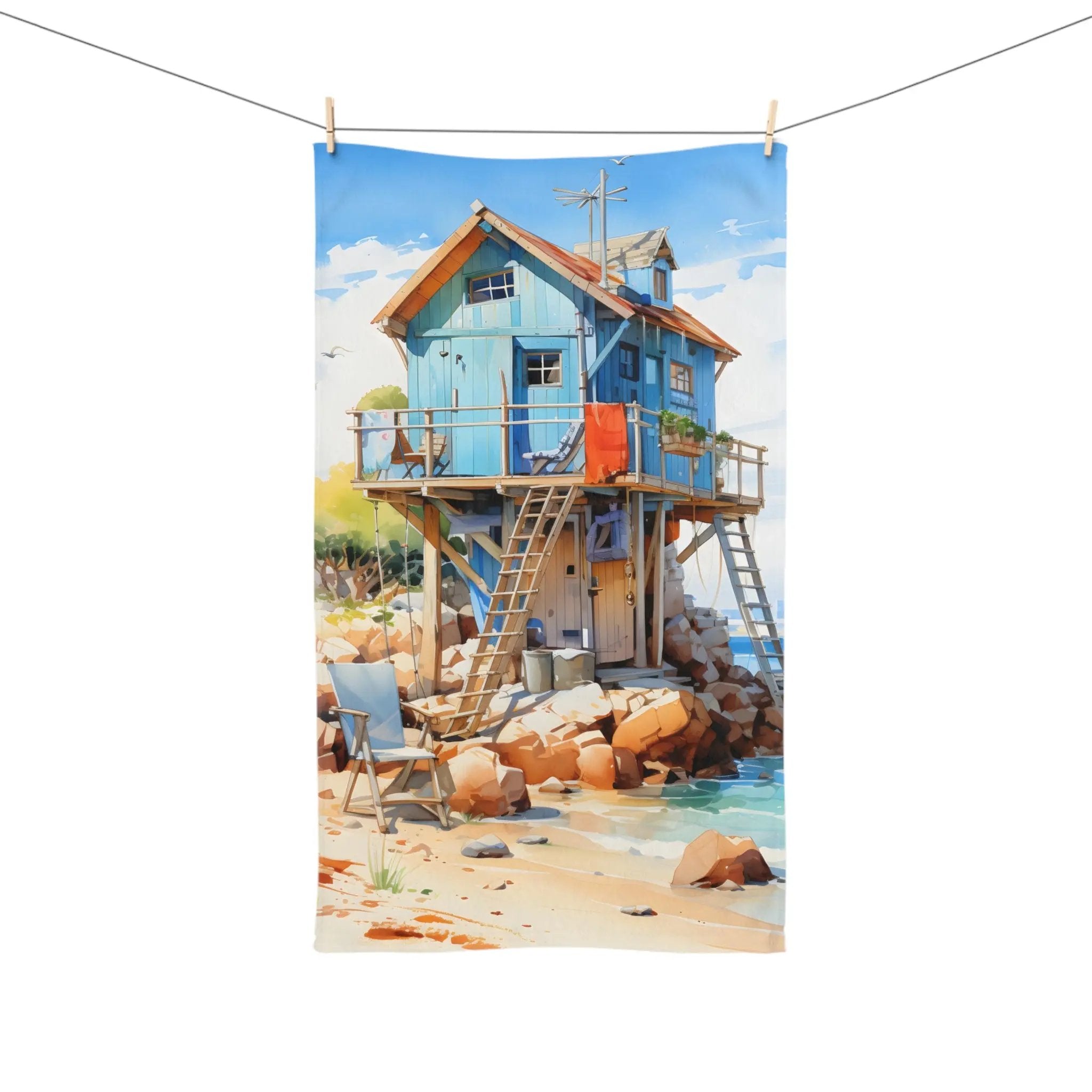 Hand towel | a painting of a blue house on a beach