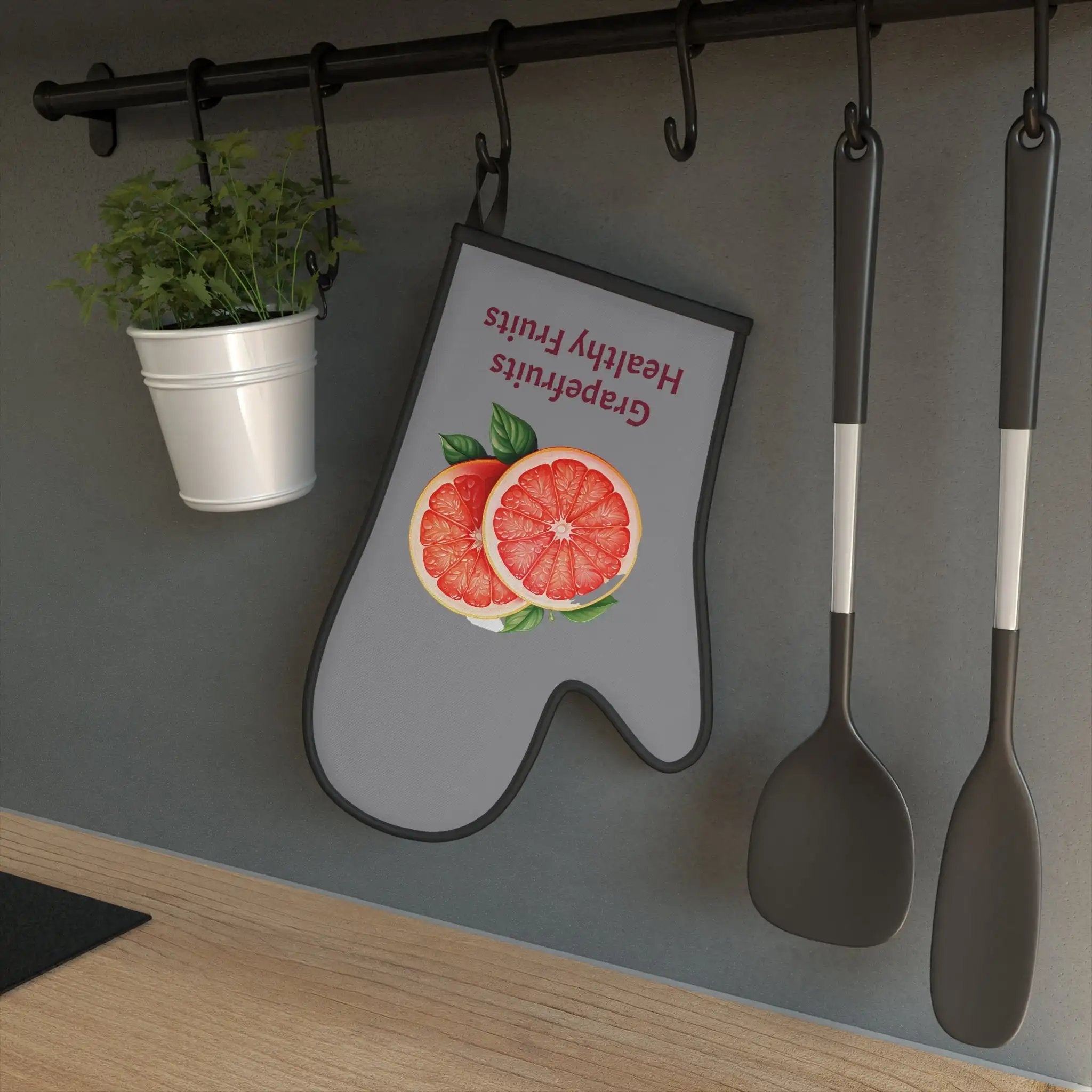 oven mitt | there is a sign on the wall with spoons and a potted plant