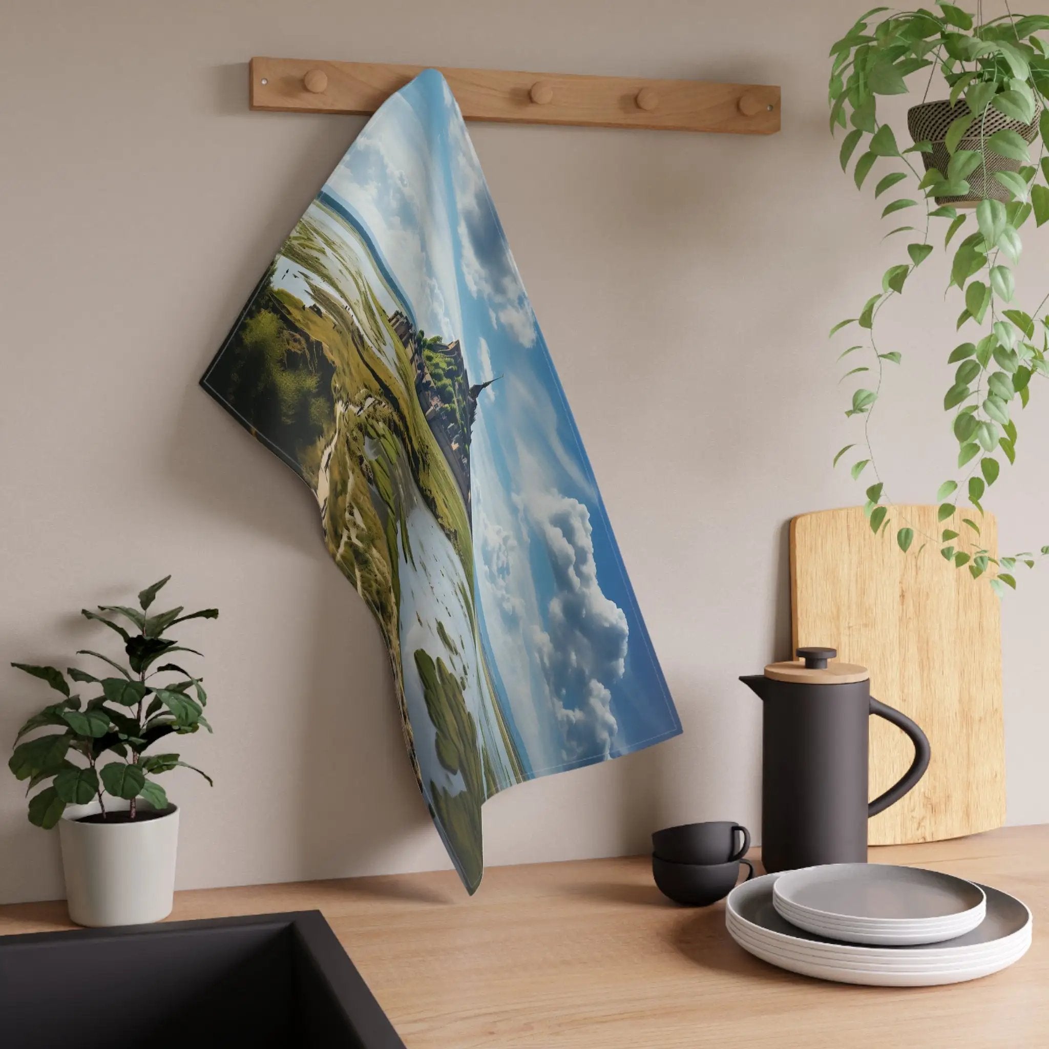 Kitchen Towel | a tea towel hanging on a wall next to a potted plant