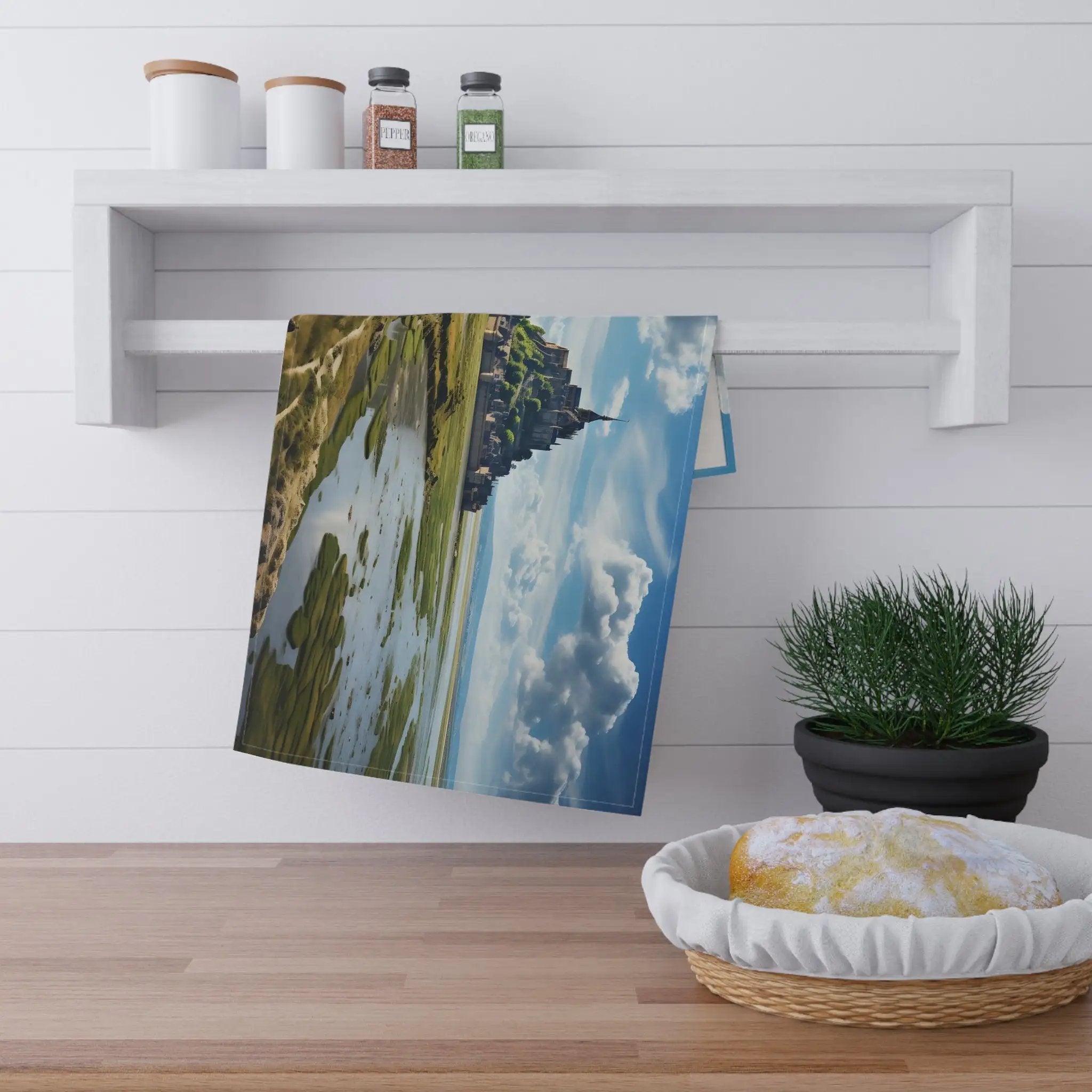 Kitchen Towel | a picture hanging on a wall next to a potted plant