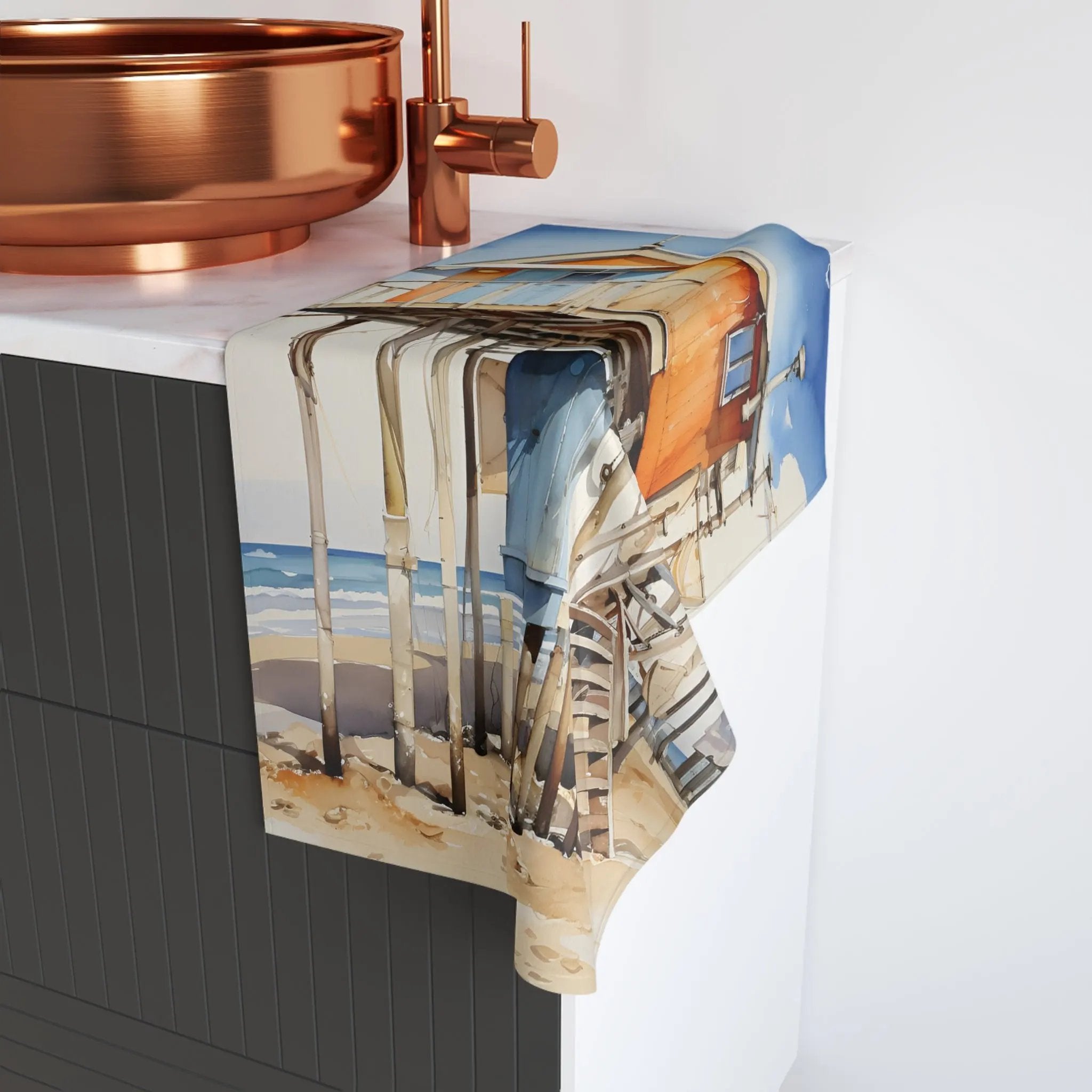 Hand towel | a kitchen counter with a copper sink and a picture of a beach