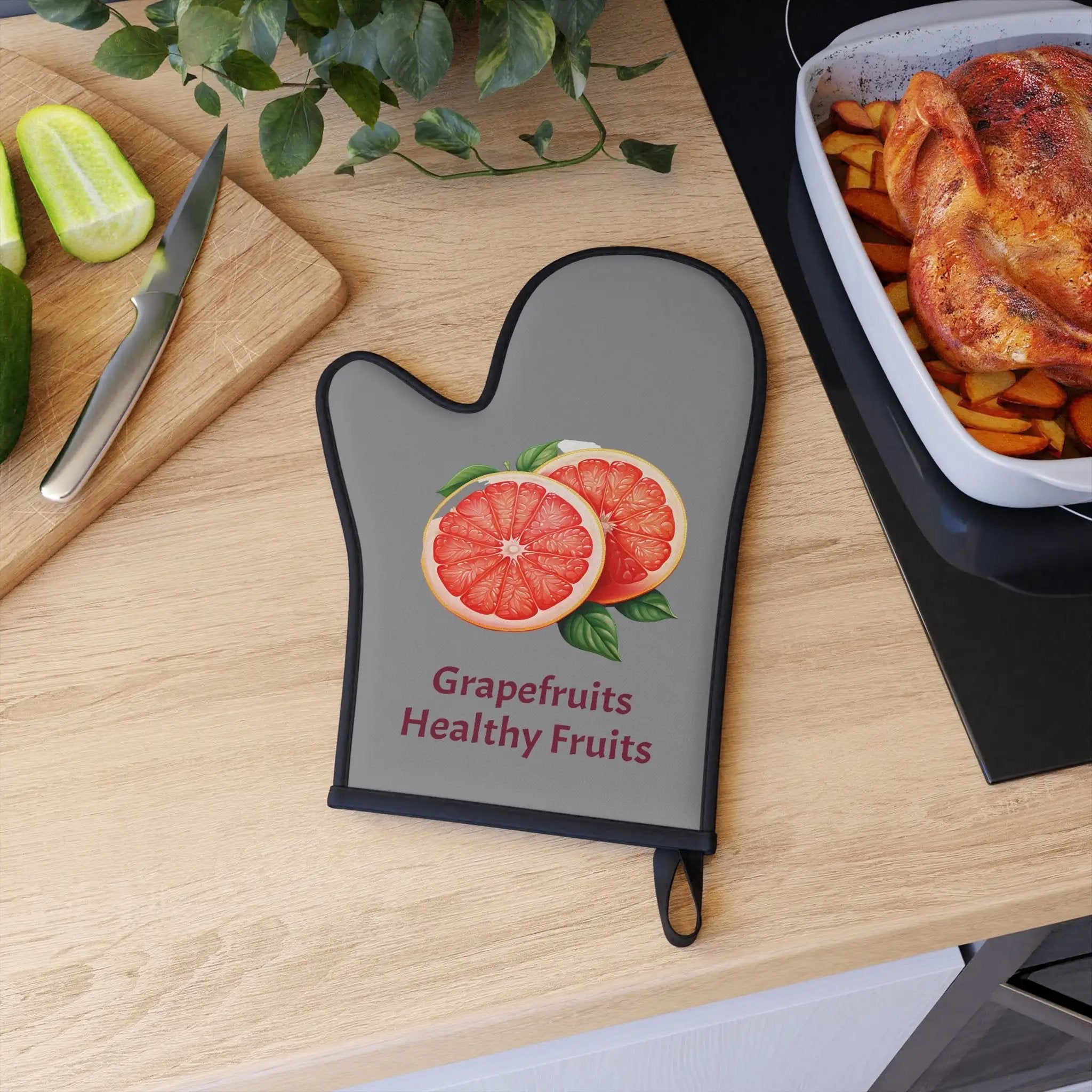 oven mitt | a cutting board with a grapefruits healthy fruits cutting board on it