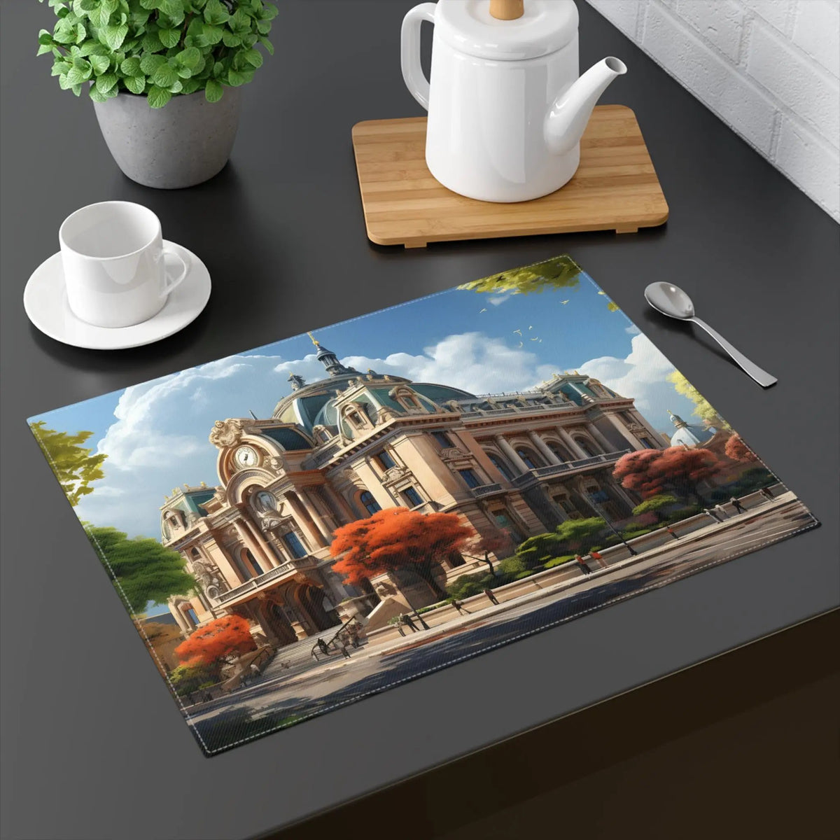 Placemat | a table with a teapot, cup, spoon and a picture of a building