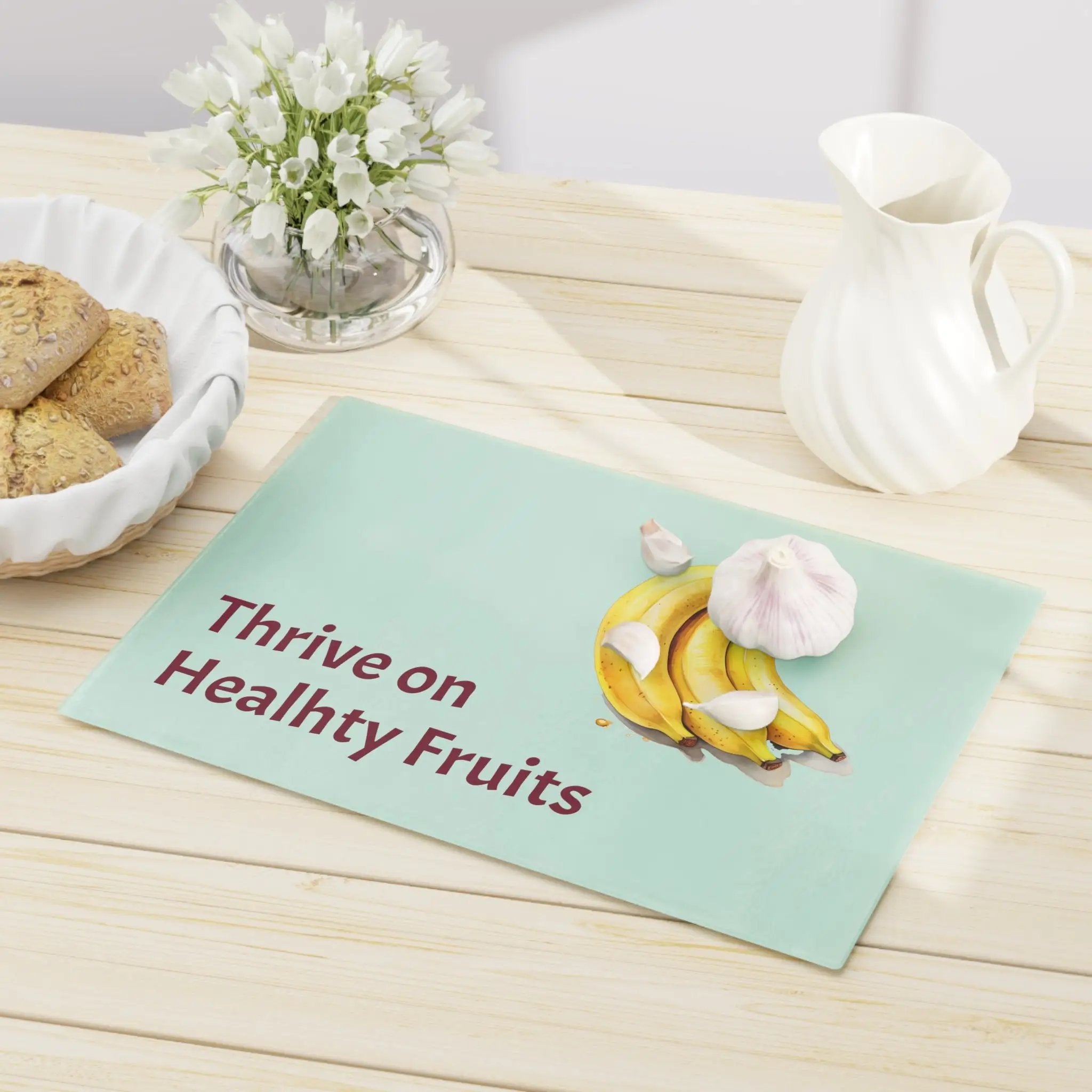 Cutting board | a table topped with a plate of cookies and a bowl of bananas