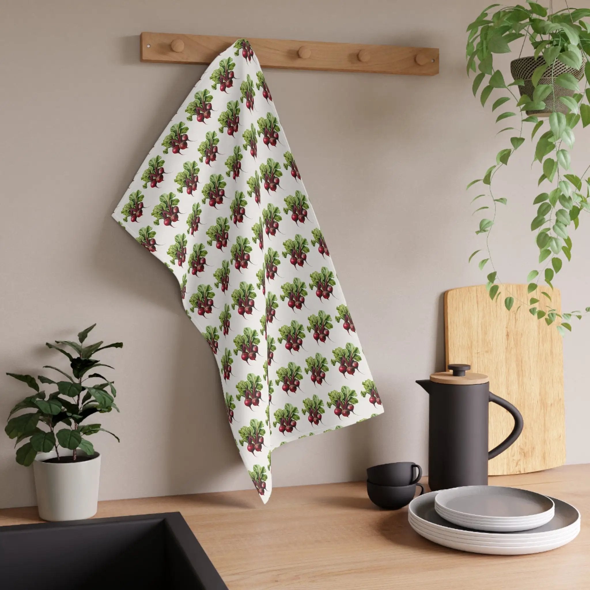 Kitchen Towel | a kitchen counter with a potted plant and a tea towel hanging on the wall