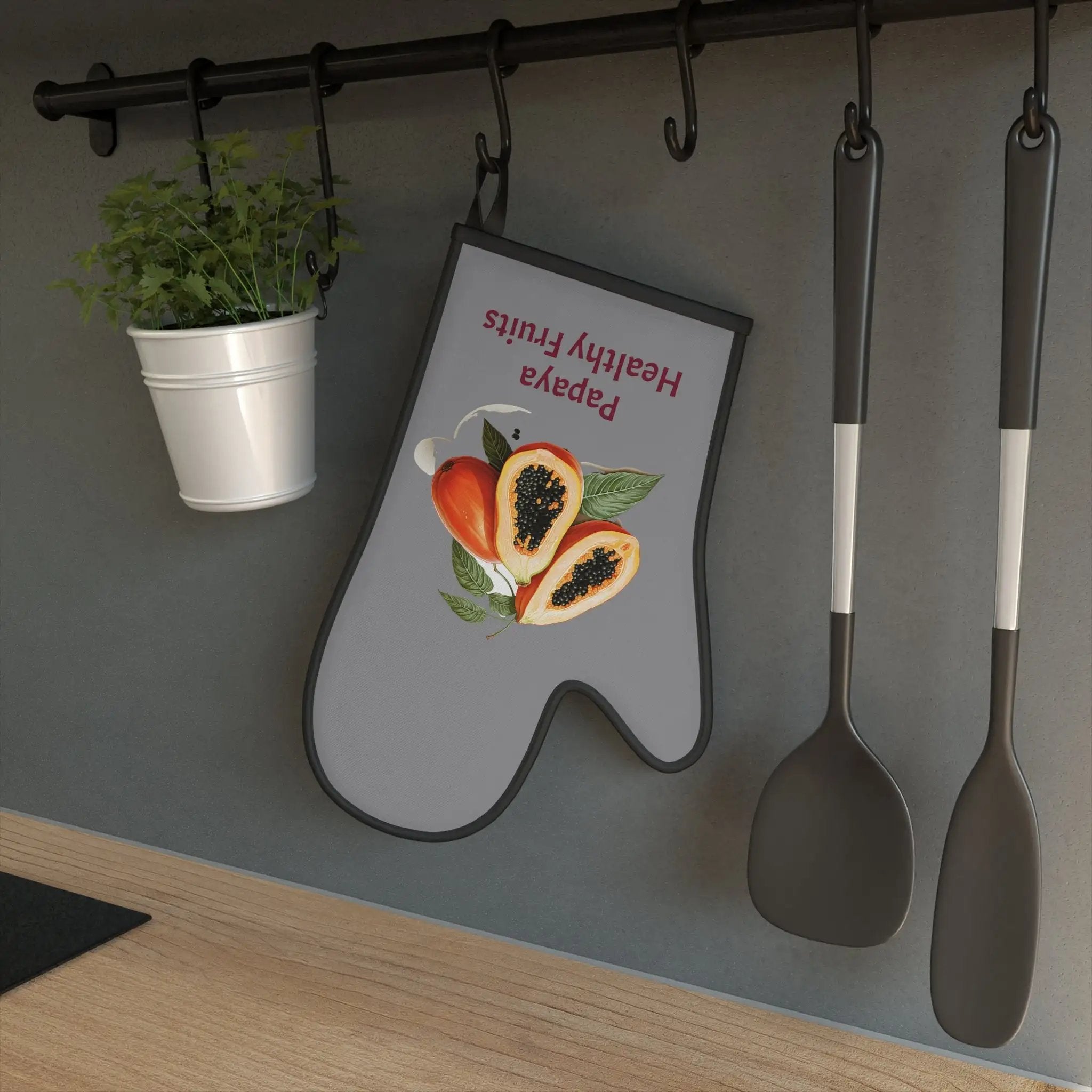 oven mitt | there is a sign on the wall with spoons and a potted plant