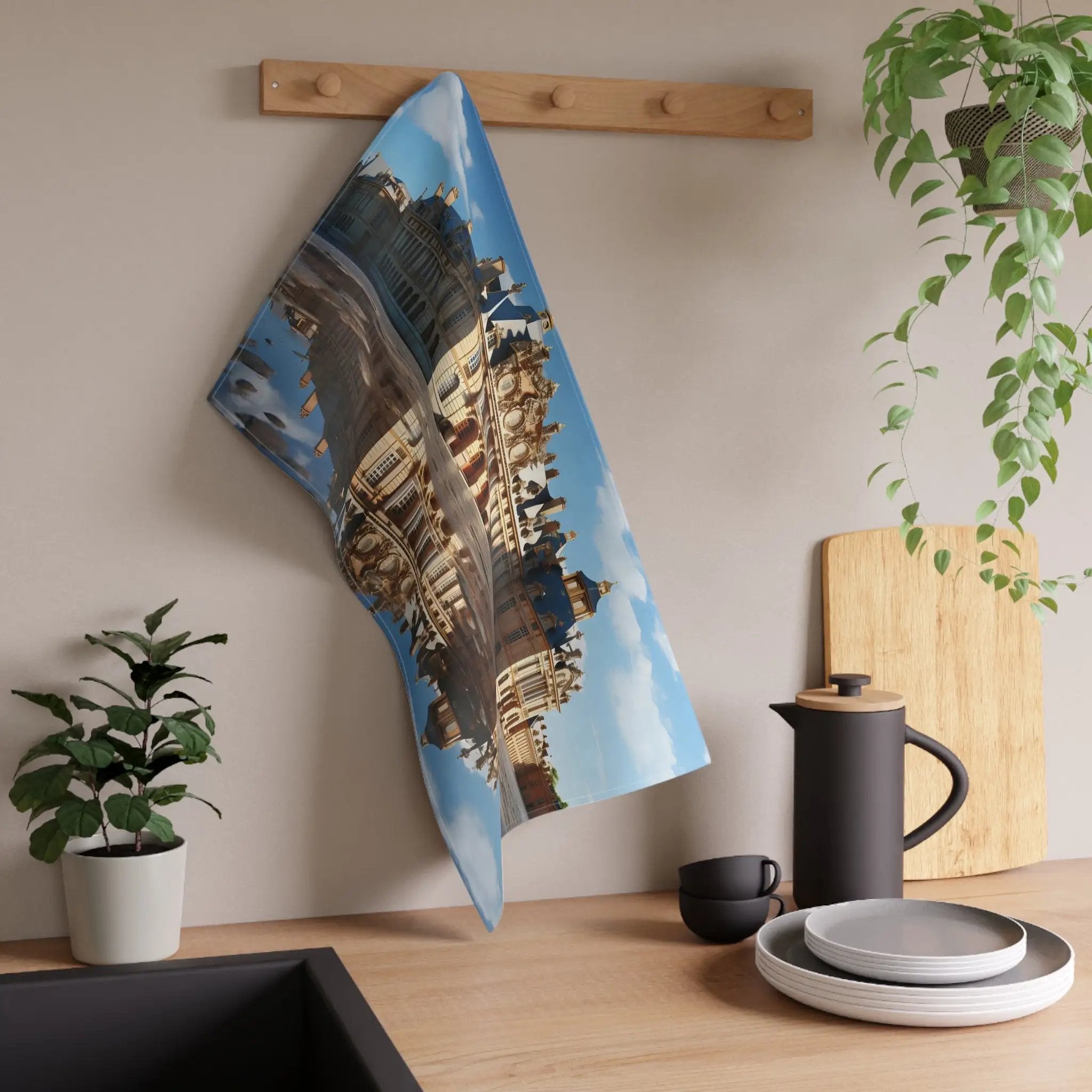 Kitchen Towel | a tea towel hanging on a wall next to a potted plant