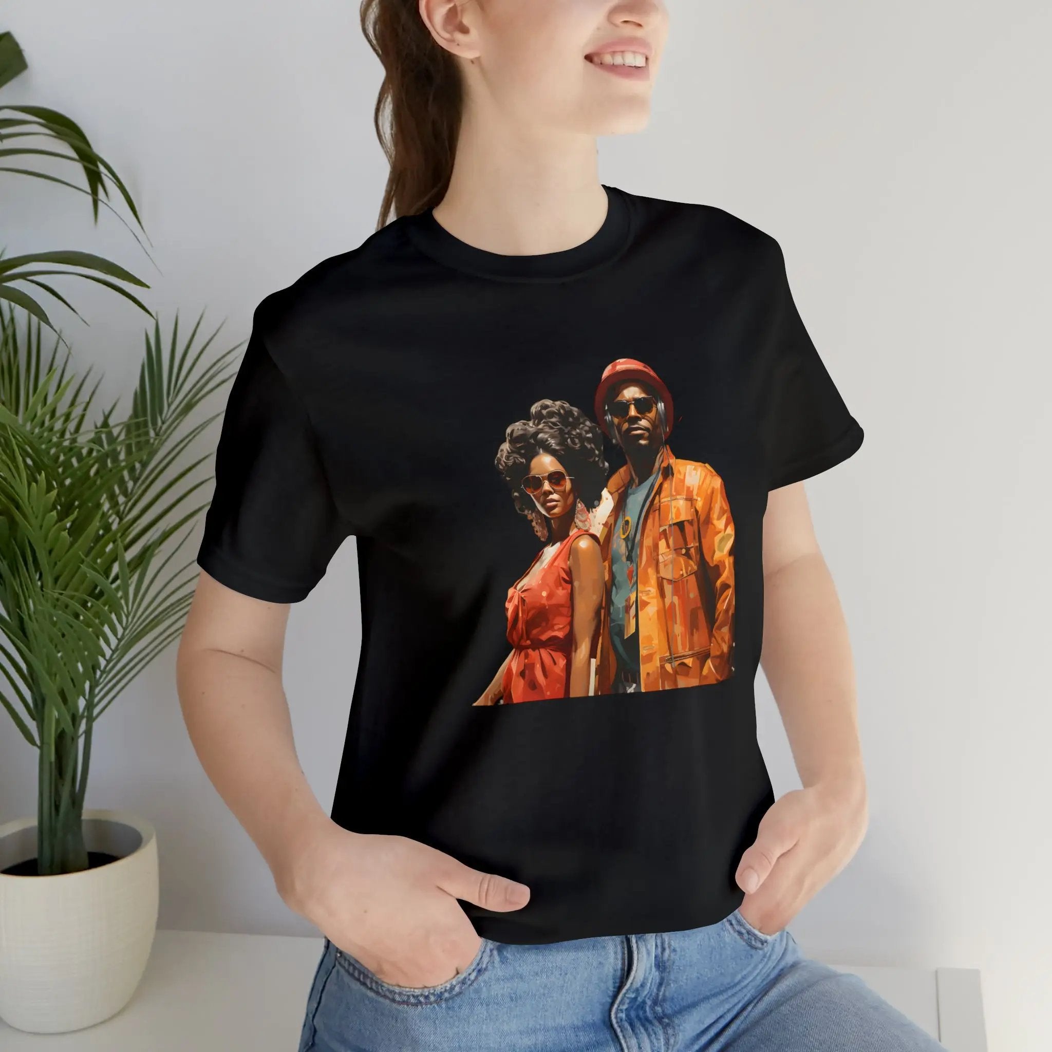 Couple t shirt | a woman wearing a black t - shirt with a picture of two people on it