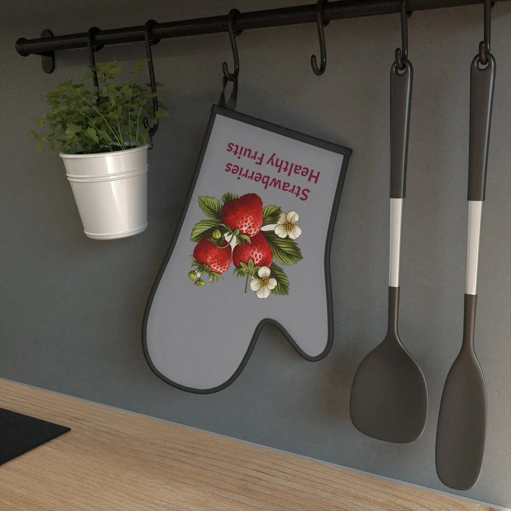 oven mitt | a kitchen with a potted plant and spoons hanging on a wall