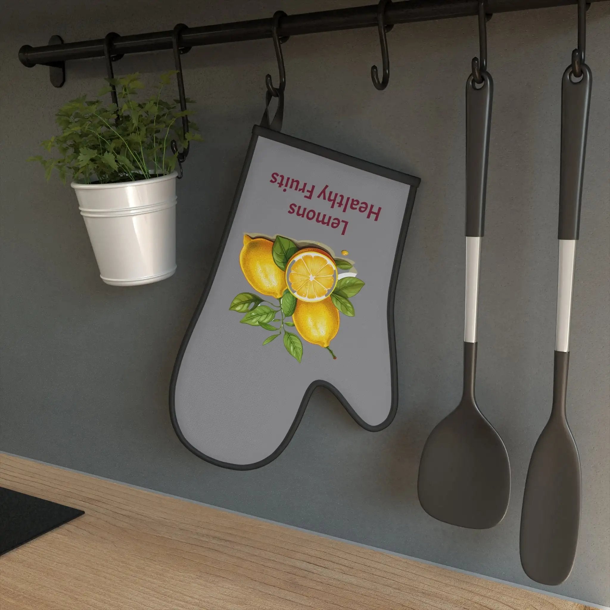 oven mitt | a kitchen with a potted plant and spoons hanging on the wall