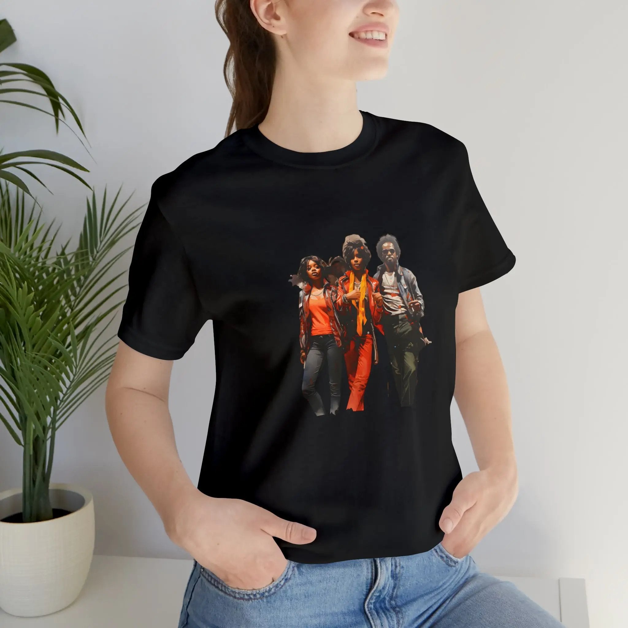 Couple t shirt | a woman wearing a black t - shirt with a group of people on it