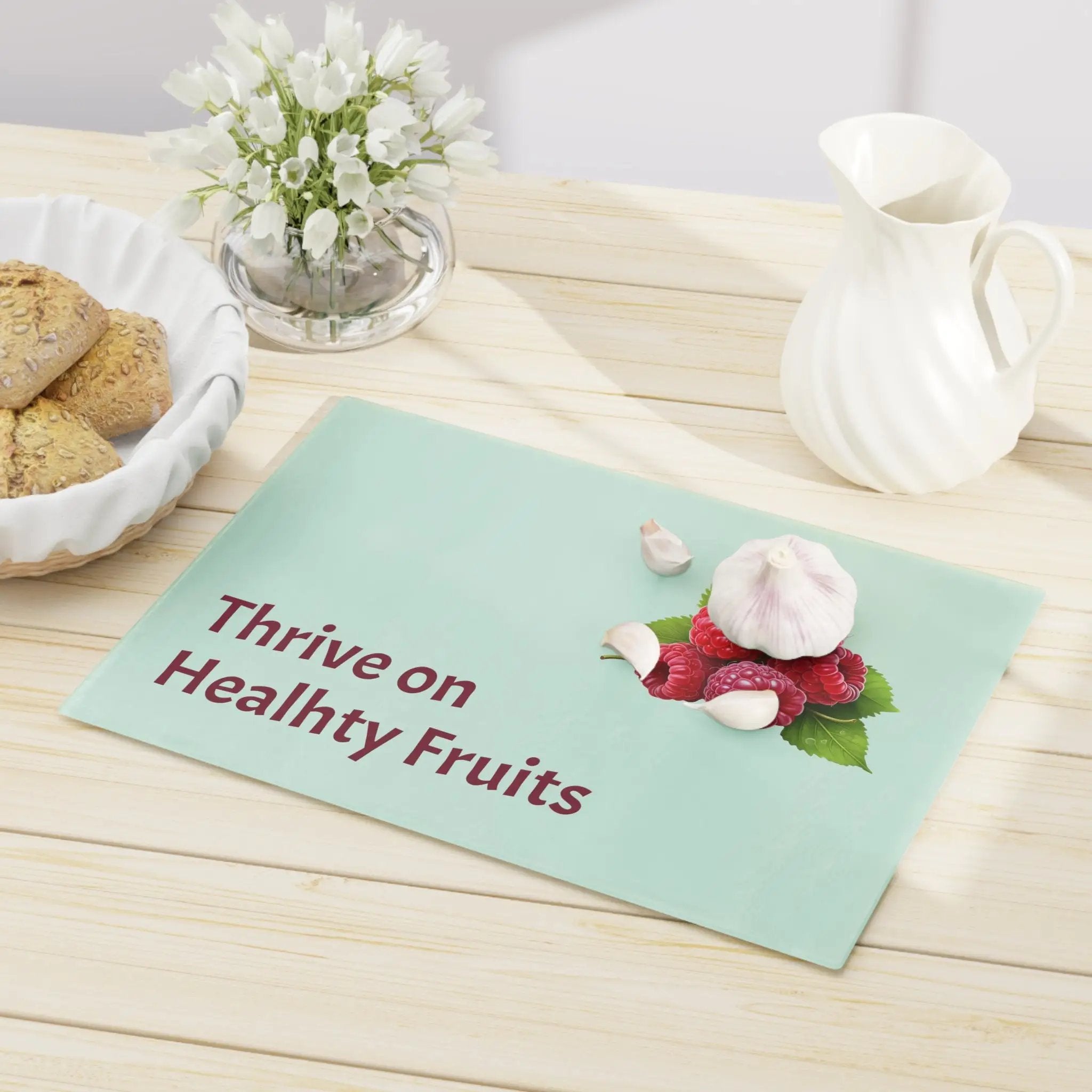 Cutting board | a table topped with a plate of cookies and a bowl of flowers