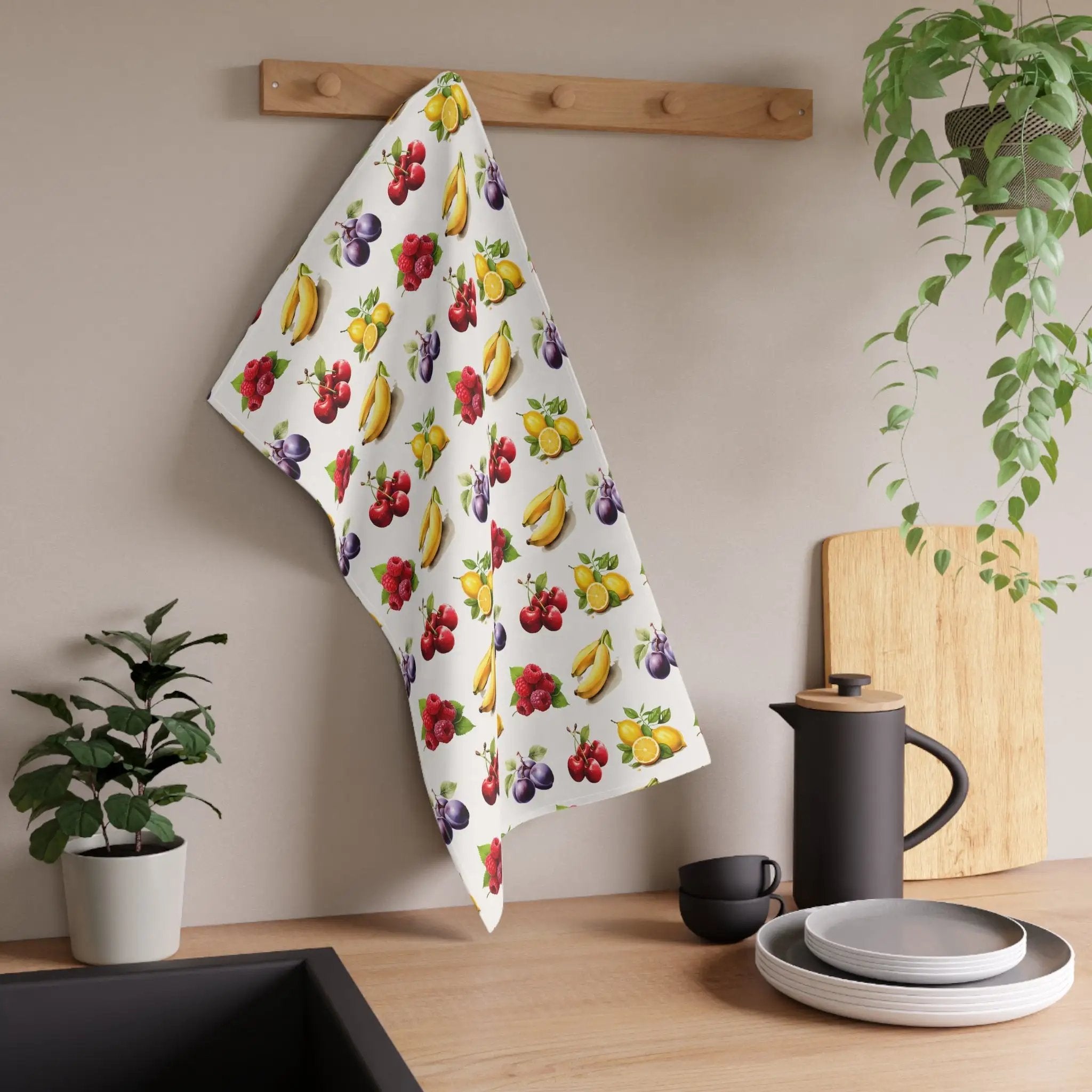 Kitchen Towel | a kitchen counter with a potted plant and a kitchen towel hanging on the wall