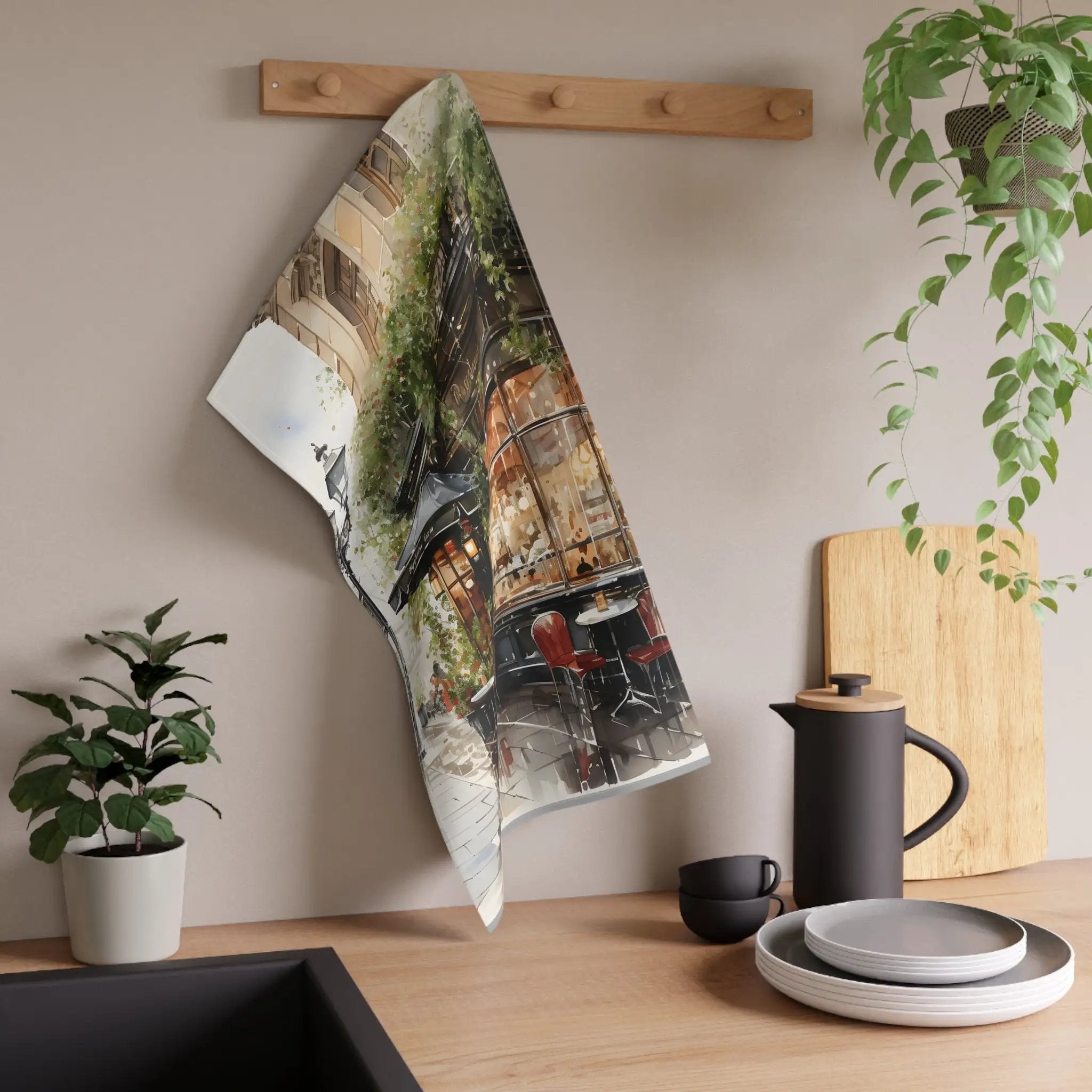 Kitchen Towel | a tea towel hanging on a wall next to a potted plant